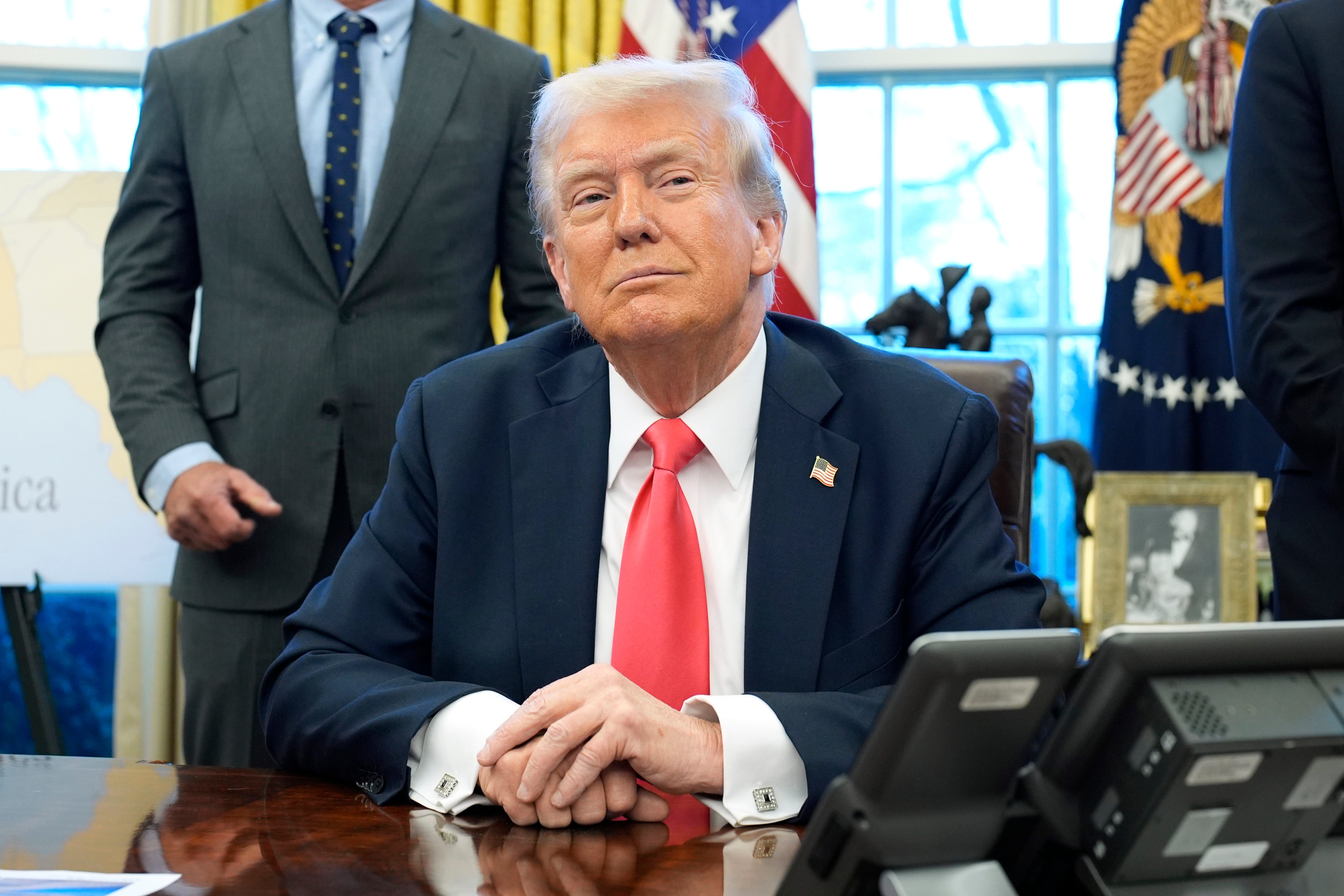 US President Donald Trump speaks to reporters after signing executive orders in the Oval Office of the White House in Washington on February 25. Photo: TNS