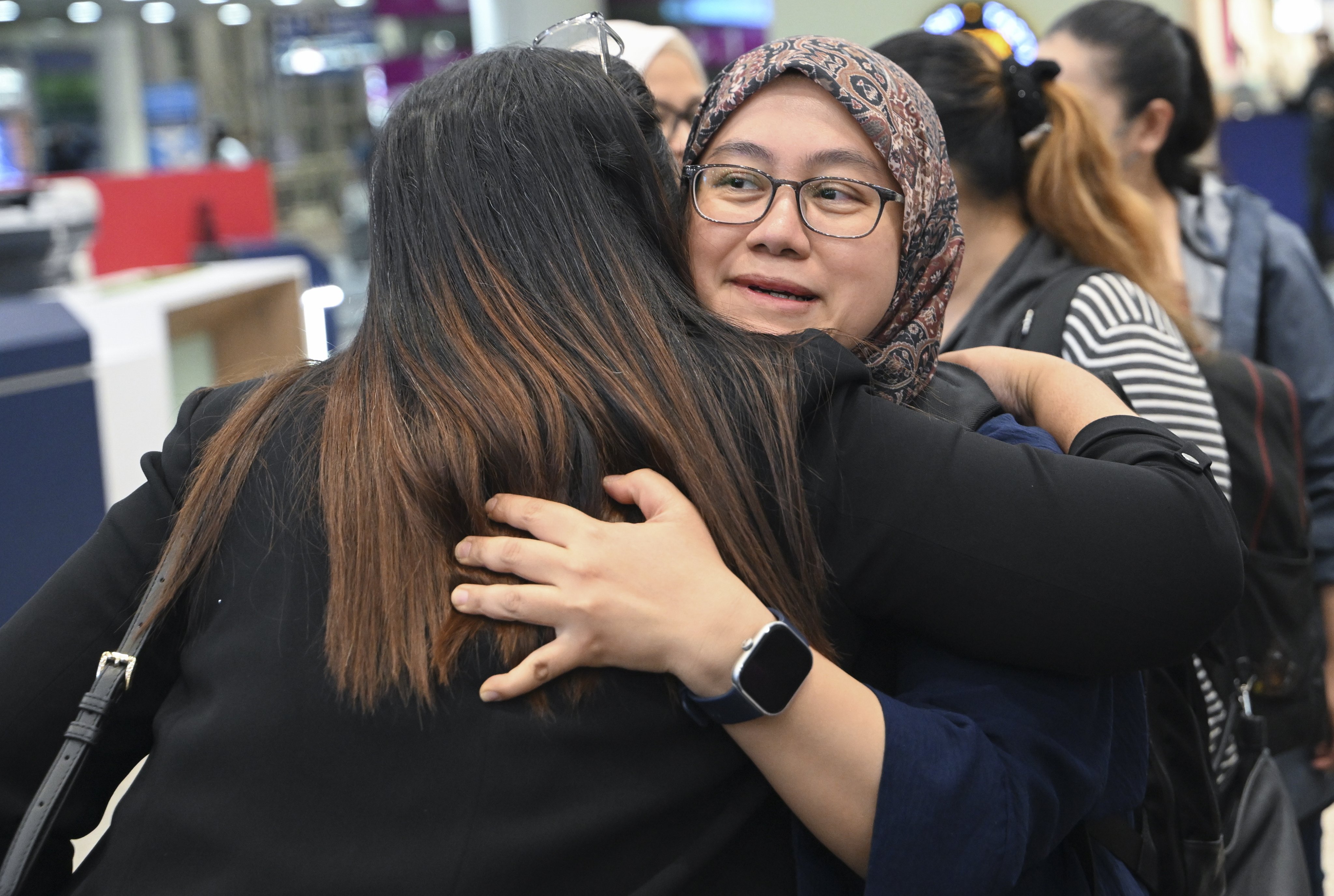 Evacuees embrace loved ones at Kuala Lumpur International Airport following their escape from conflict-hit Iran. Photo: Malaysian Ministry of Foreign Affairs/EPA-EFE