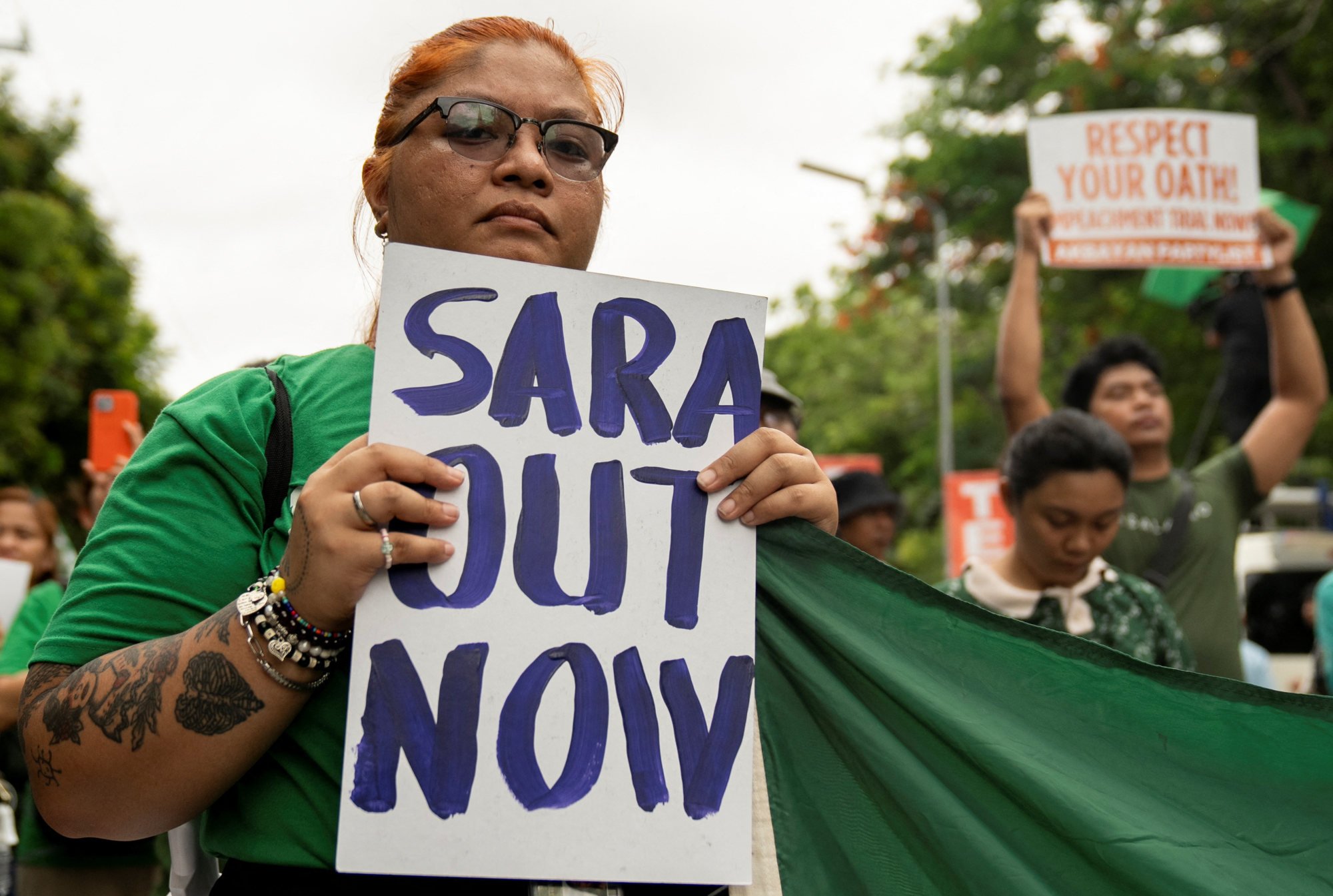 A woman carries a placard during a protest calling for the impeachment of Philippine Vice-President Sara Duterte-Carpio, outside the Senate of the Philippines on June 11. Photo: Reuters A woman carries a placard during a protest calling for the impeachment of Philippine Vice-President Sara Duterte-Carpio, outside the Senate of the Philippines on June 11. Photo: Reuters