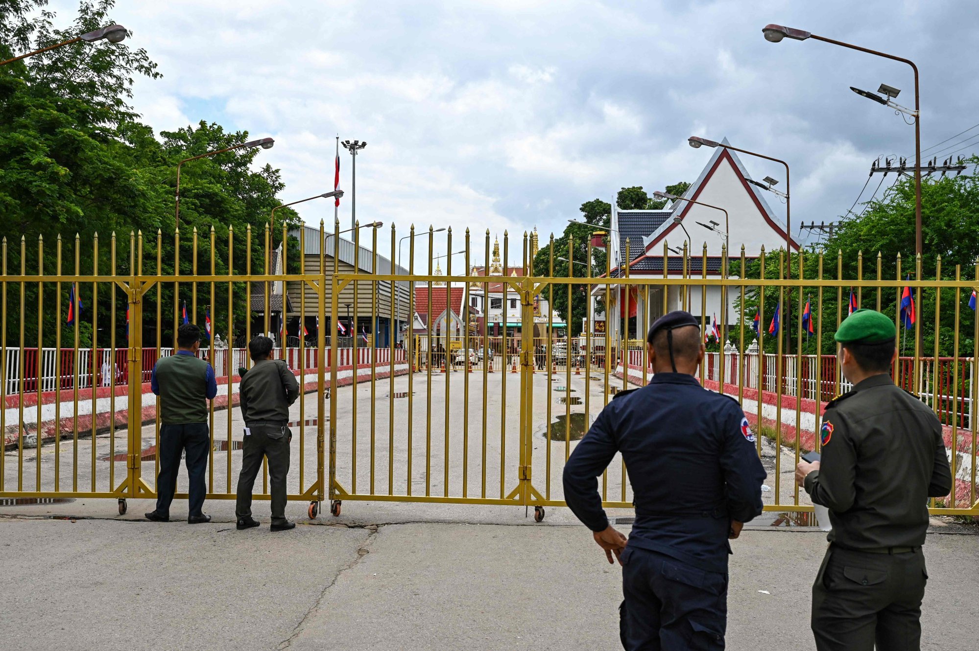 Cambodian police officials stand at the Poipet international border checkpoint between Cambodia and Thailand. Photo: AFP Cambodian police officials stand at the Poipet international border checkpoint between Cambodia and Thailand. Photo: AFP