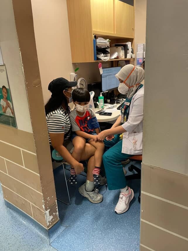 Winda’s son, 5, receiving medical attention after he was allegedly attacked with a wine bottle while he and his family were seated outside a coffee shop in Singapore’s Arab Street district on June 20. Photo: Winda