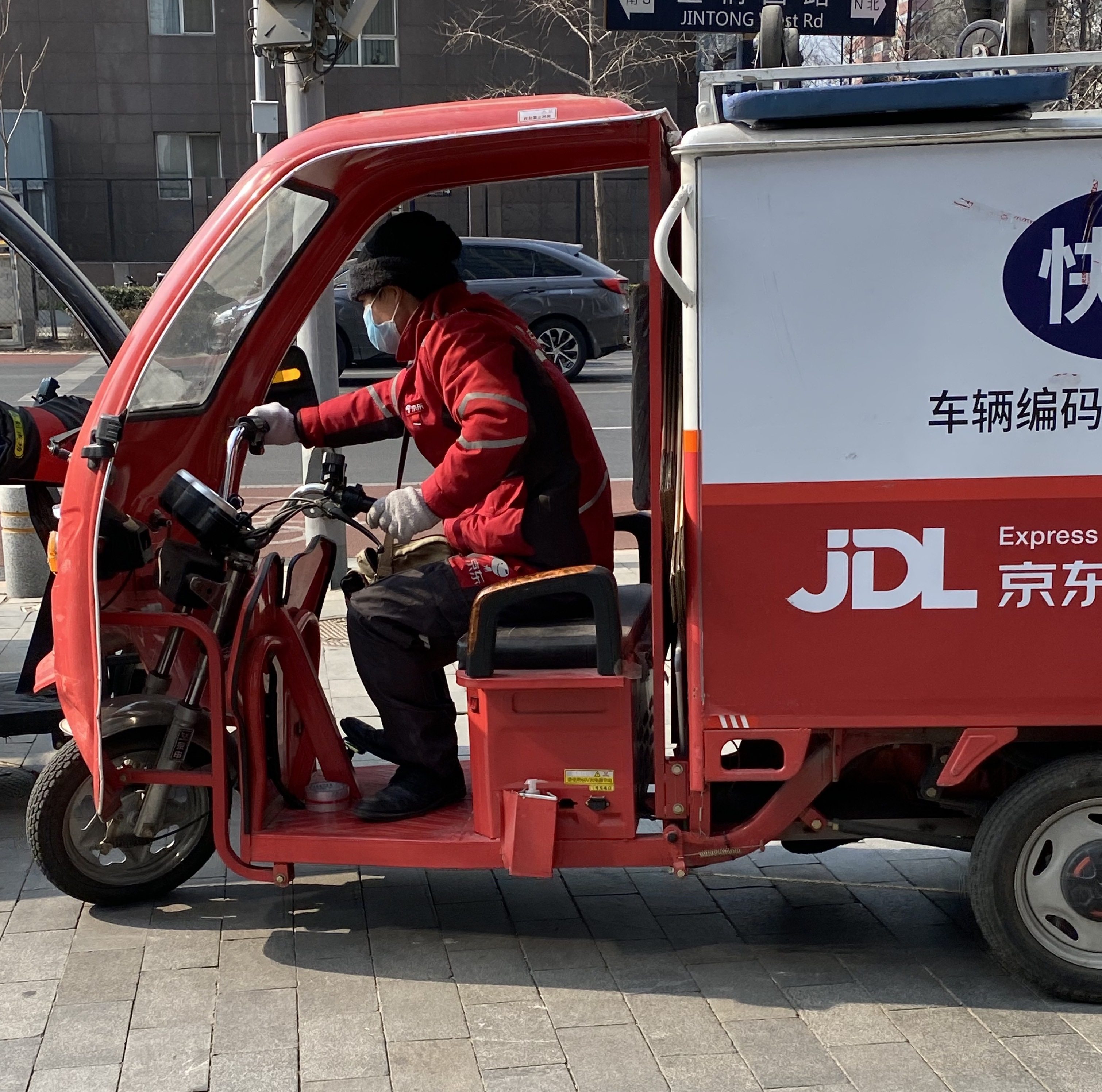 A JD Logistics delivery driver on the streets of Beijing. Photo: Minghe Hu