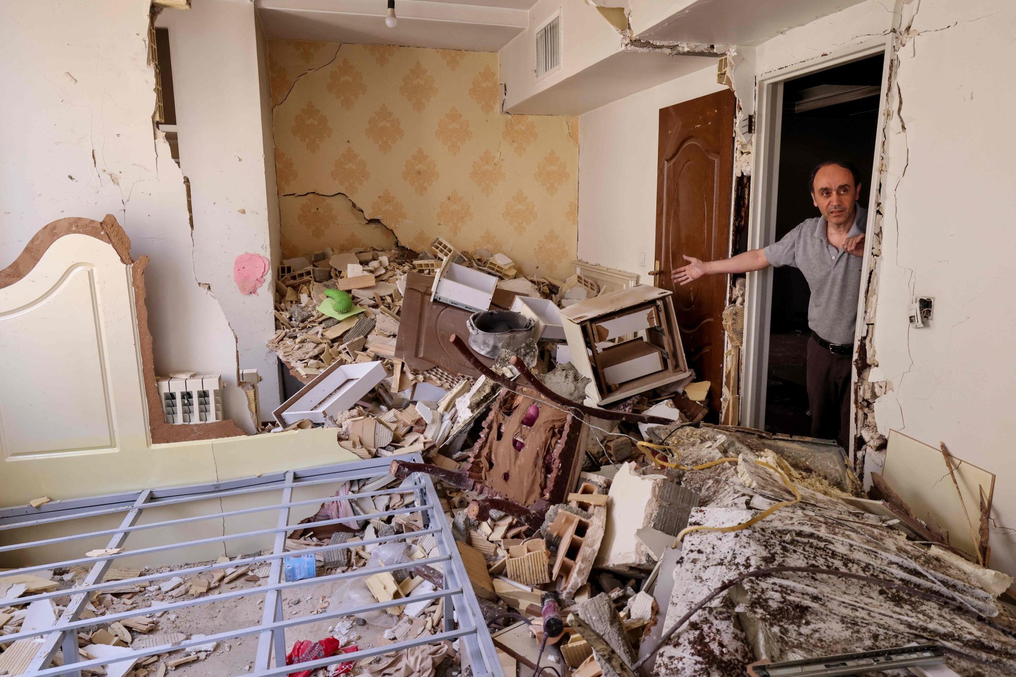 A resident gestures as he shows the destruction in his building after it was hit in an Israeli strike, in Tehran, on Wednesday amid a ceasefire brokered by the United States. Photo: AFP A resident gestures as he shows the destruction in his building after it was hit in an Israeli strike, in Tehran, on Wednesday amid a ceasefire brokered by the United States. Photo: AFP