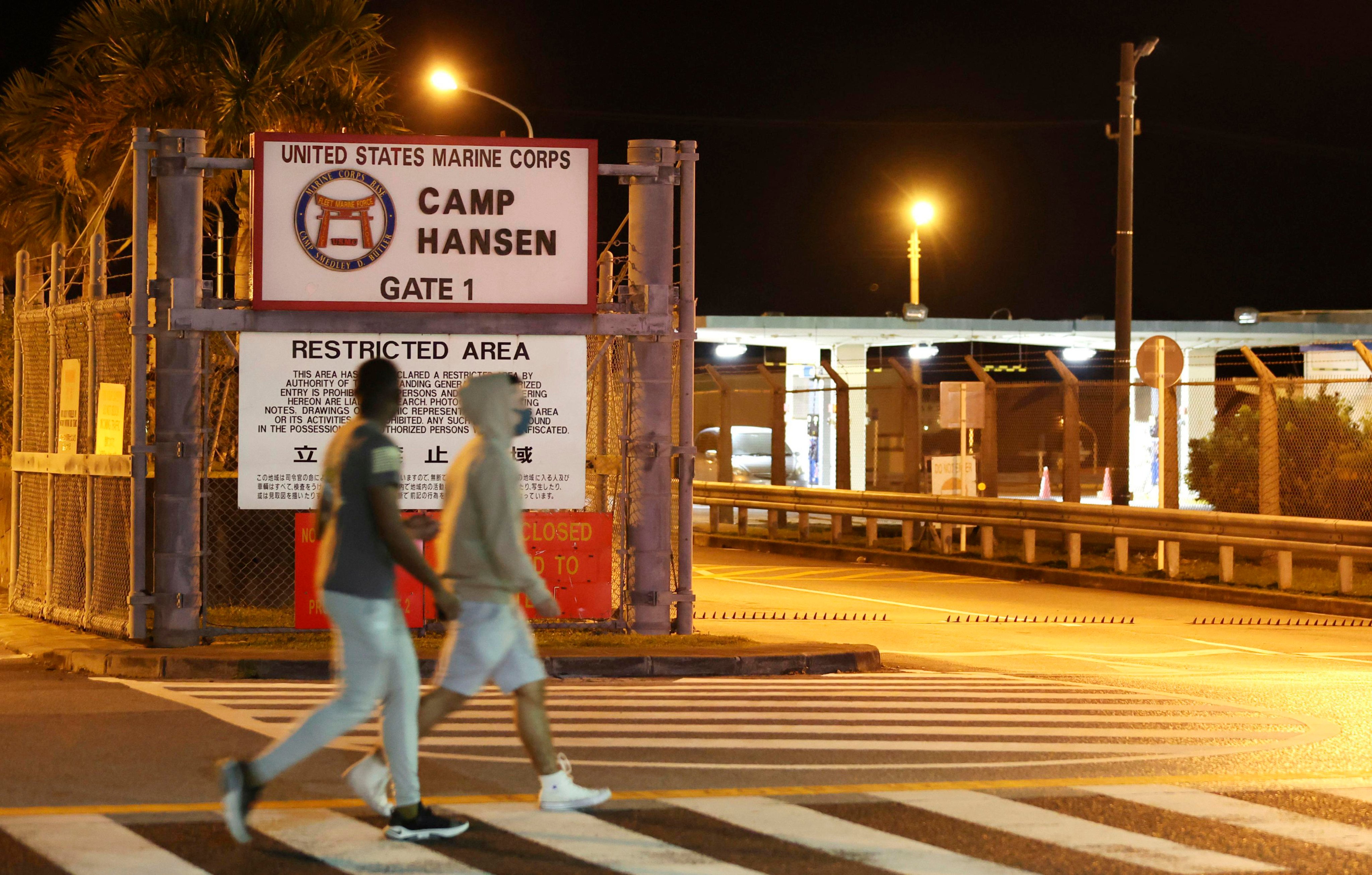 People walk past the US Marine Corps’ Camp Hansen in Japan’s Okinawa prefecture. Photo: Kyodo / AP