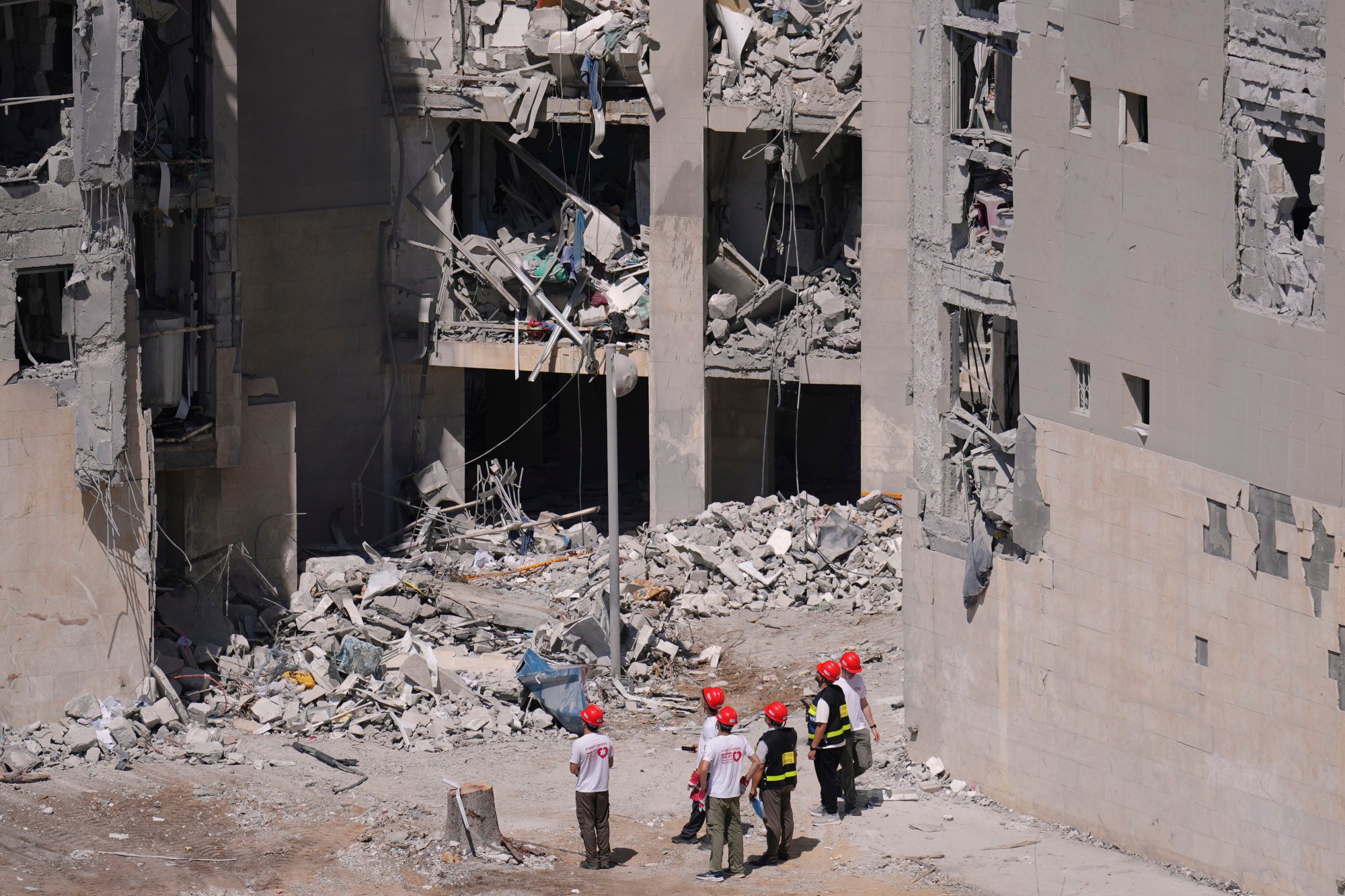 Israel’s official surveyors and volunteers check a damaged residential building a day after a direct missile strike, launched from Iran, following the announcement of a ceasefire, in Beersheba, Israel, on Wednesday. Photo: AP Israel’s official surveyors and volunteers check a damaged residential building a day after a direct missile strike, launched from Iran, following the announcement of a ceasefire, in Beersheba, Israel, on Wednesday. Photo: AP
