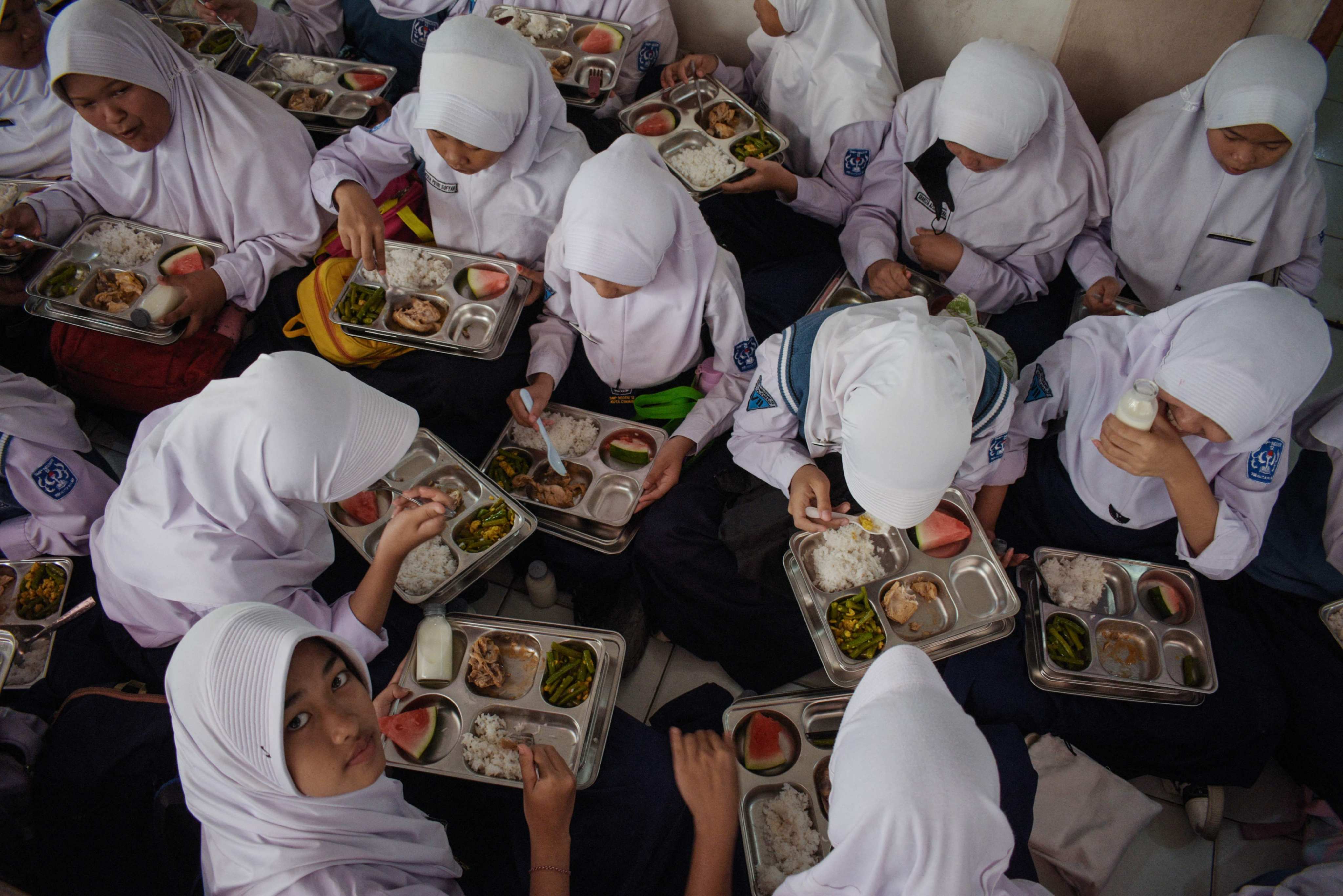 Students eat lunch on the first day of a free-meal programme at a junior high school in Cimahi, West Java, earlier this year. Photo: AFP
