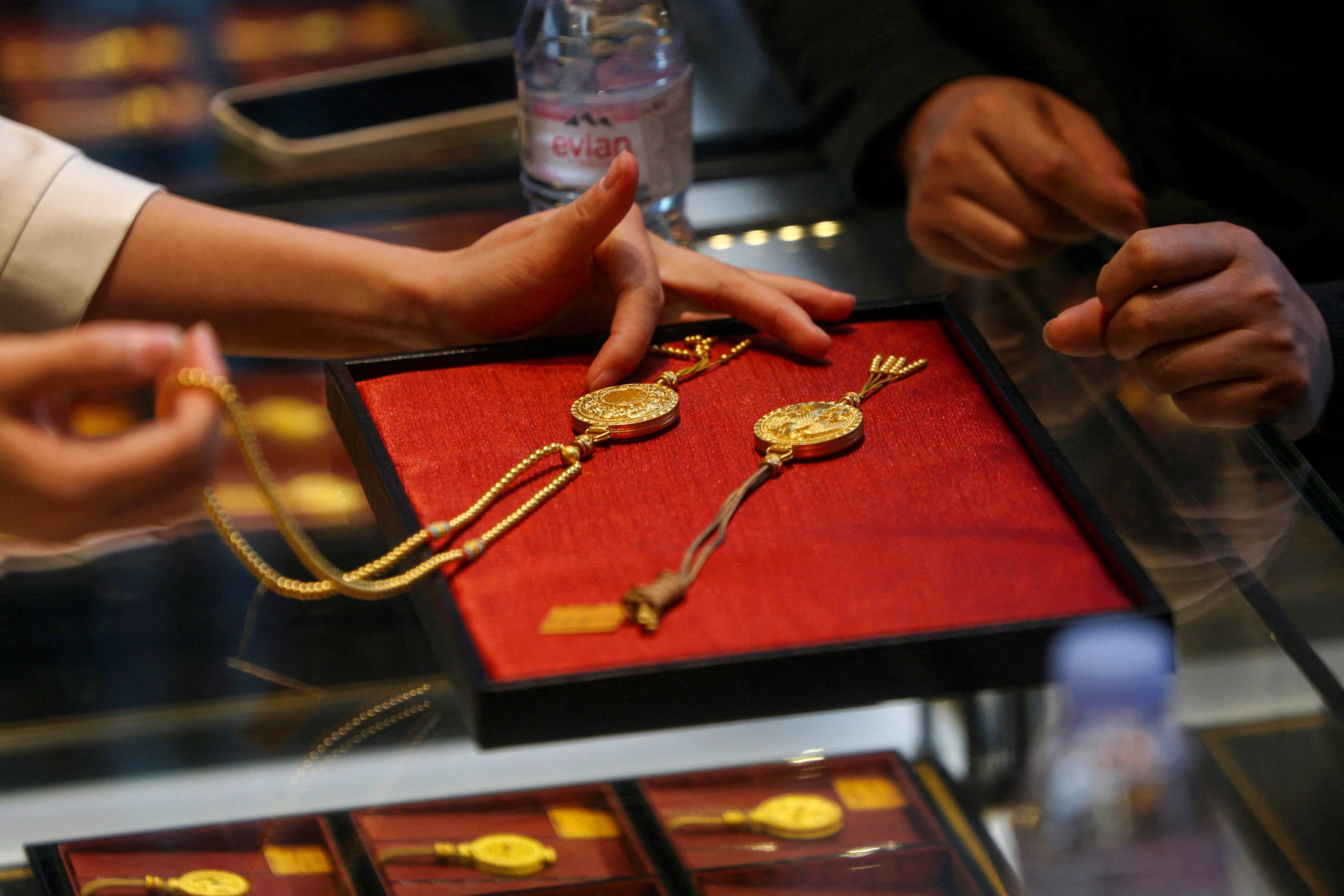 A staff member attends to a customer at a Laopu Gold jewellery store in Beijing in March. Photo: Reuters