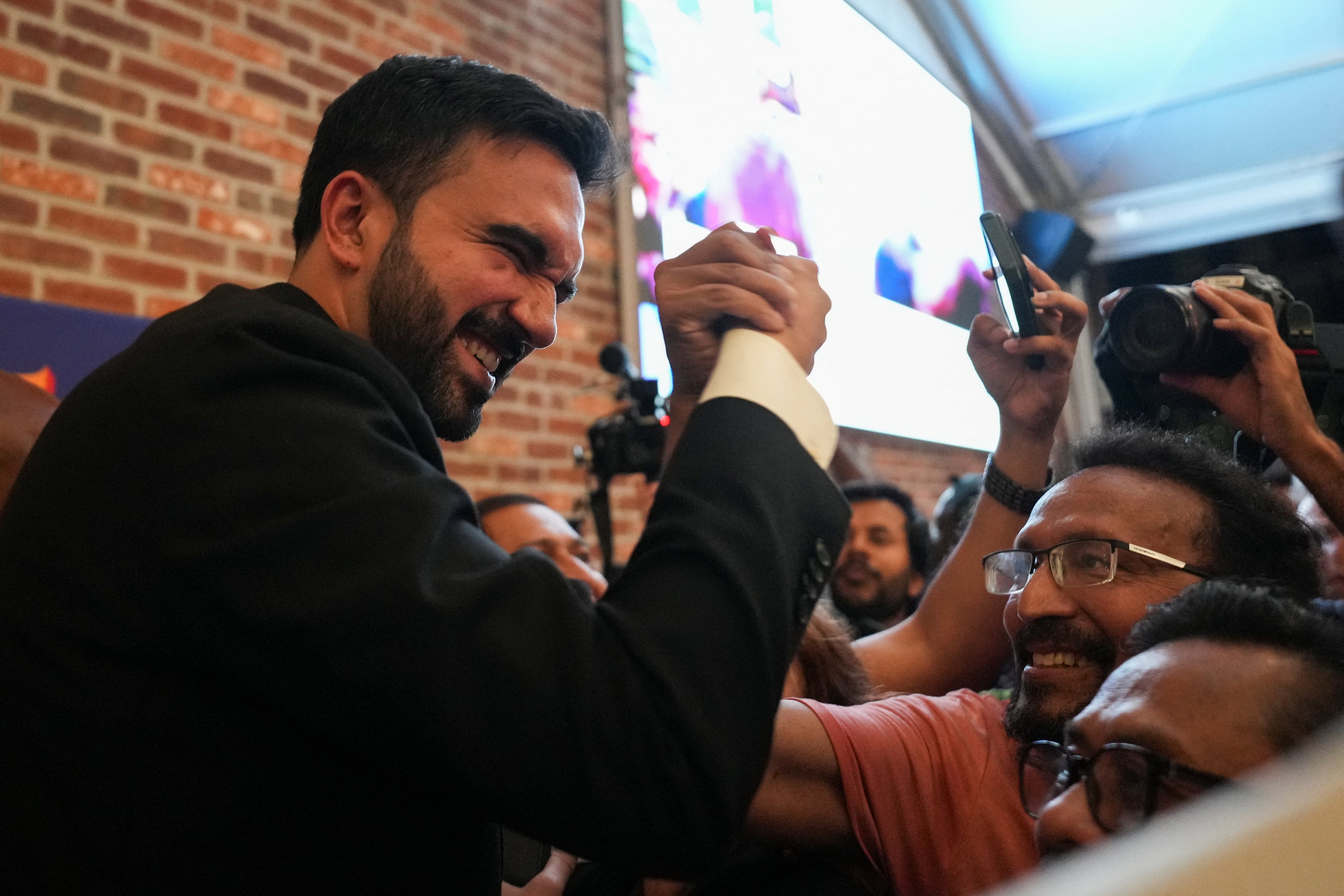 Zohran Mamdani greets a supporter during a watch party for his primary election. Photo: Reuters