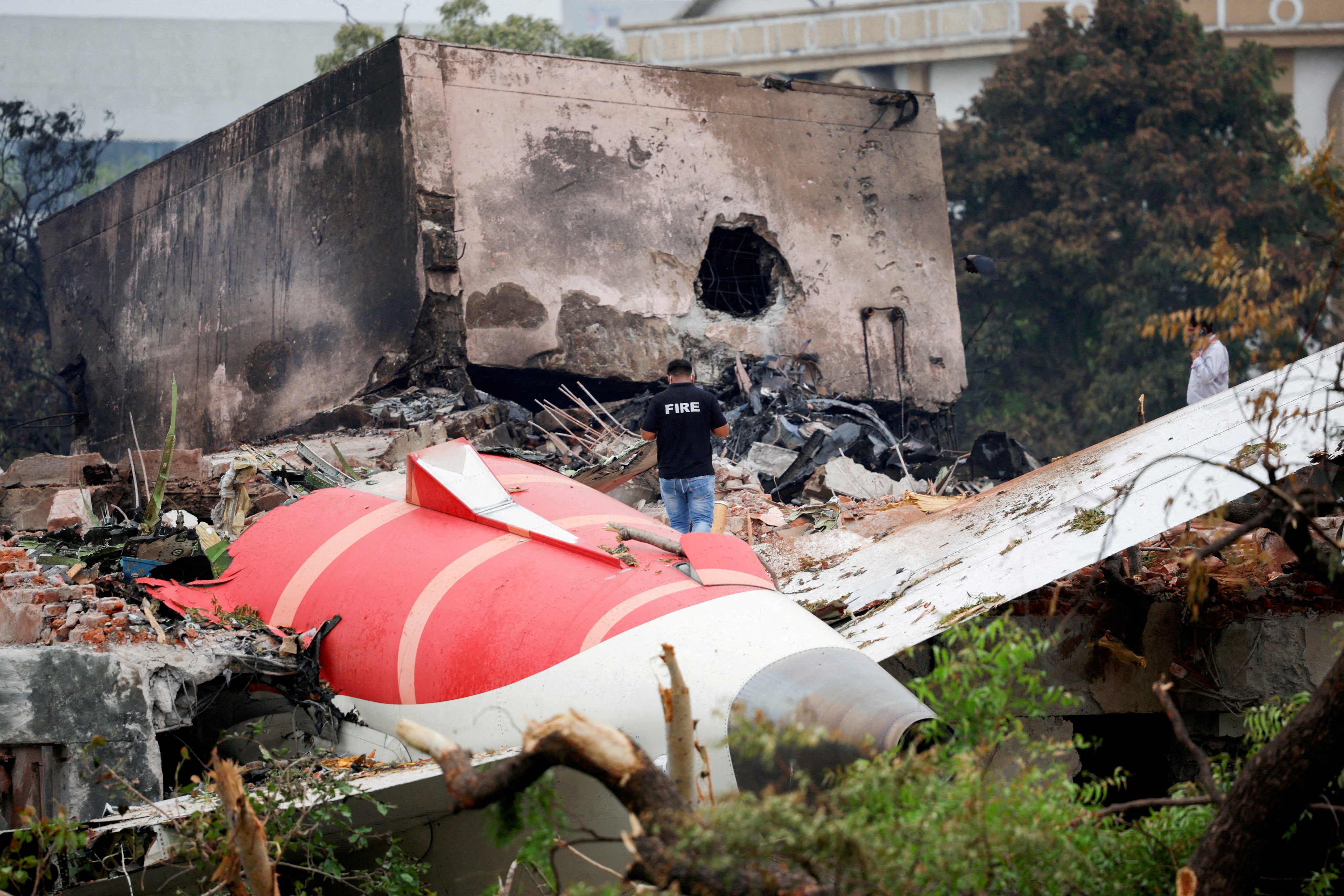 A firefighter stands next to the crashed Air India plane in Ahmedabad on June 13. Photo: Reuters