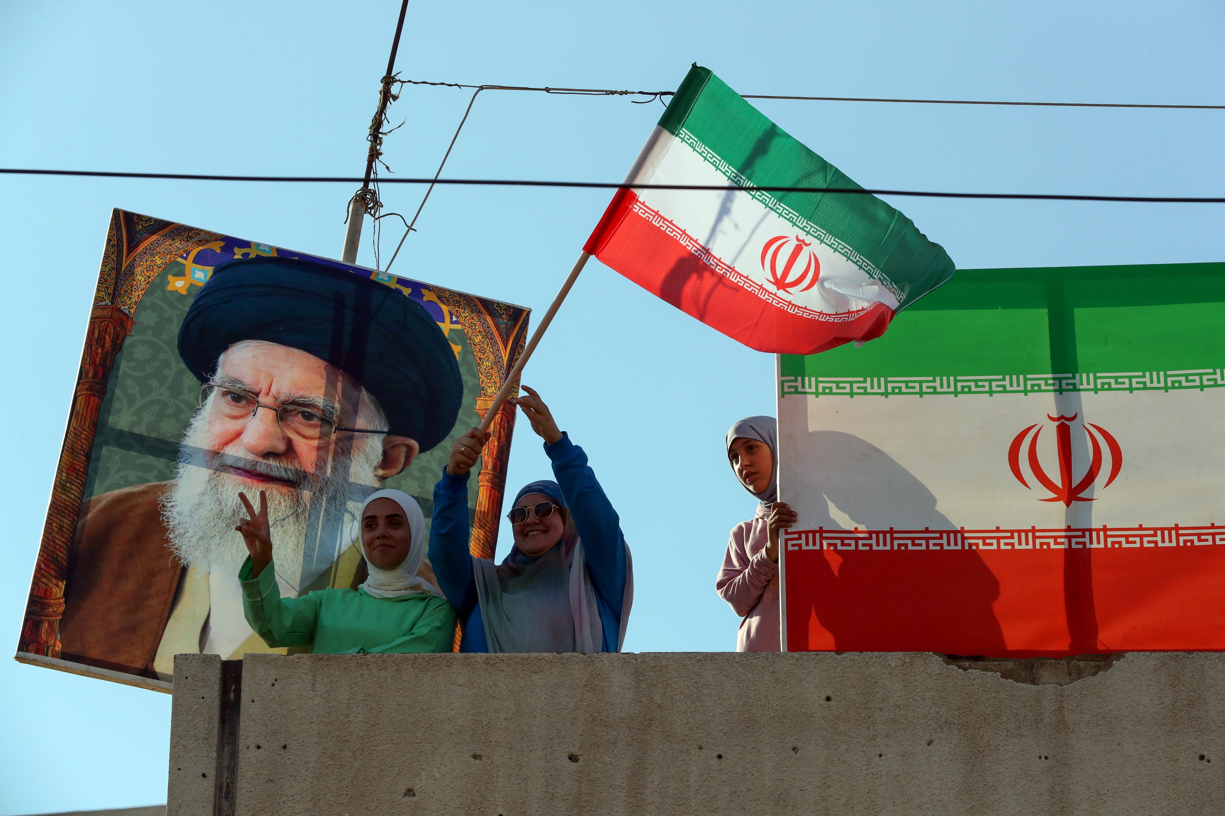 Supporters of Iran’s Supreme Leader Ayatollah Ali Khamenei (in picture) attend a celebration organised by Hezbollah in front of the Iranian embassy in Beirut, Lebanon on Wednesday. Photo: EPA