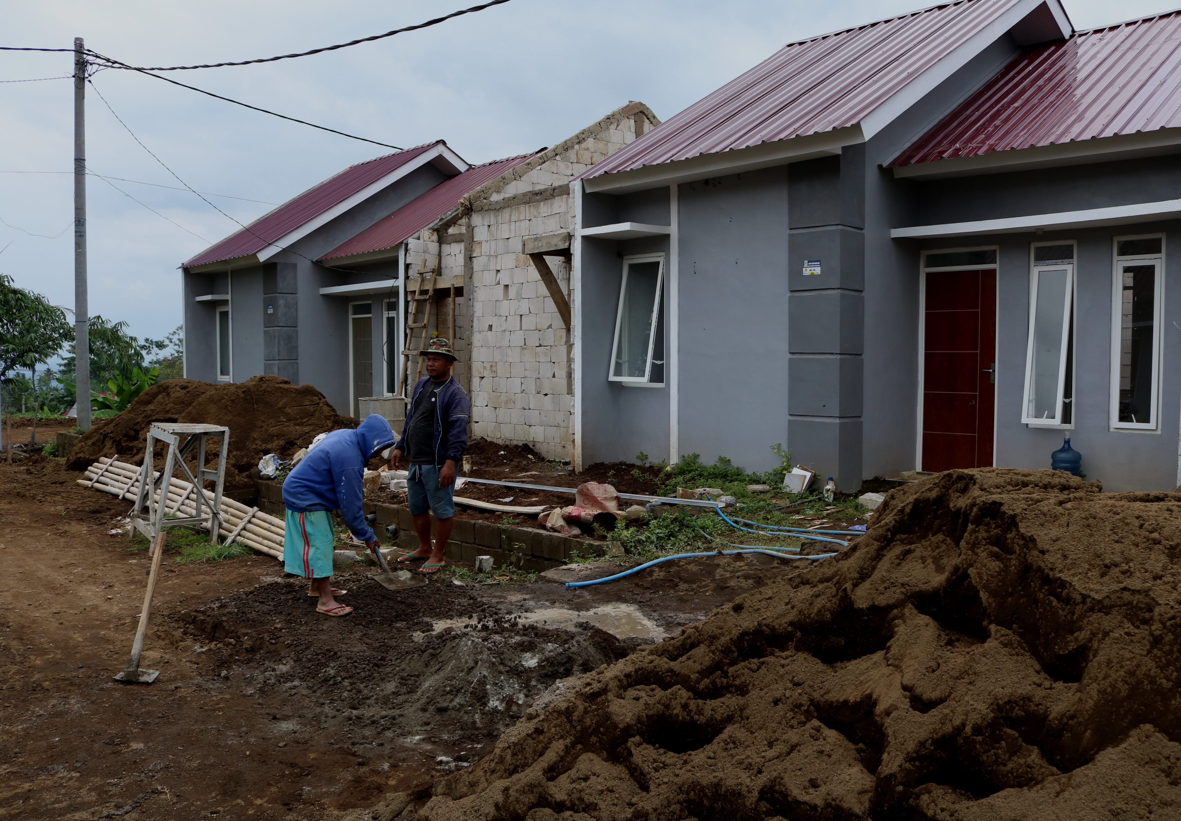 Workers build homes in a subsidised housing area in East Java, Indonesia. Photo: NurPhoto via Getty Images