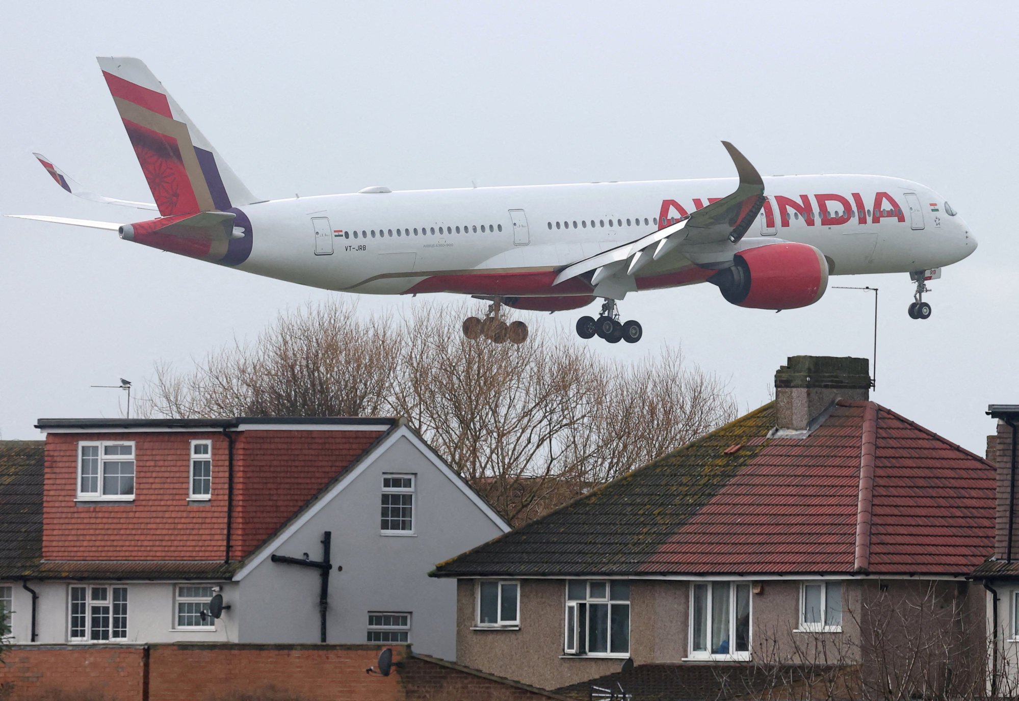 An Air India passenger plane flies near houses as it makes its landing approach at Heathrow Airport in Britain. Air India boasts the country’s most extensive flight networks with other nations. Photo: Reuters An Air India passenger plane flies near houses as it makes its landing approach at Heathrow Airport in Britain. Air India boasts the country’s most extensive flight networks with other nations. Photo: Reuters