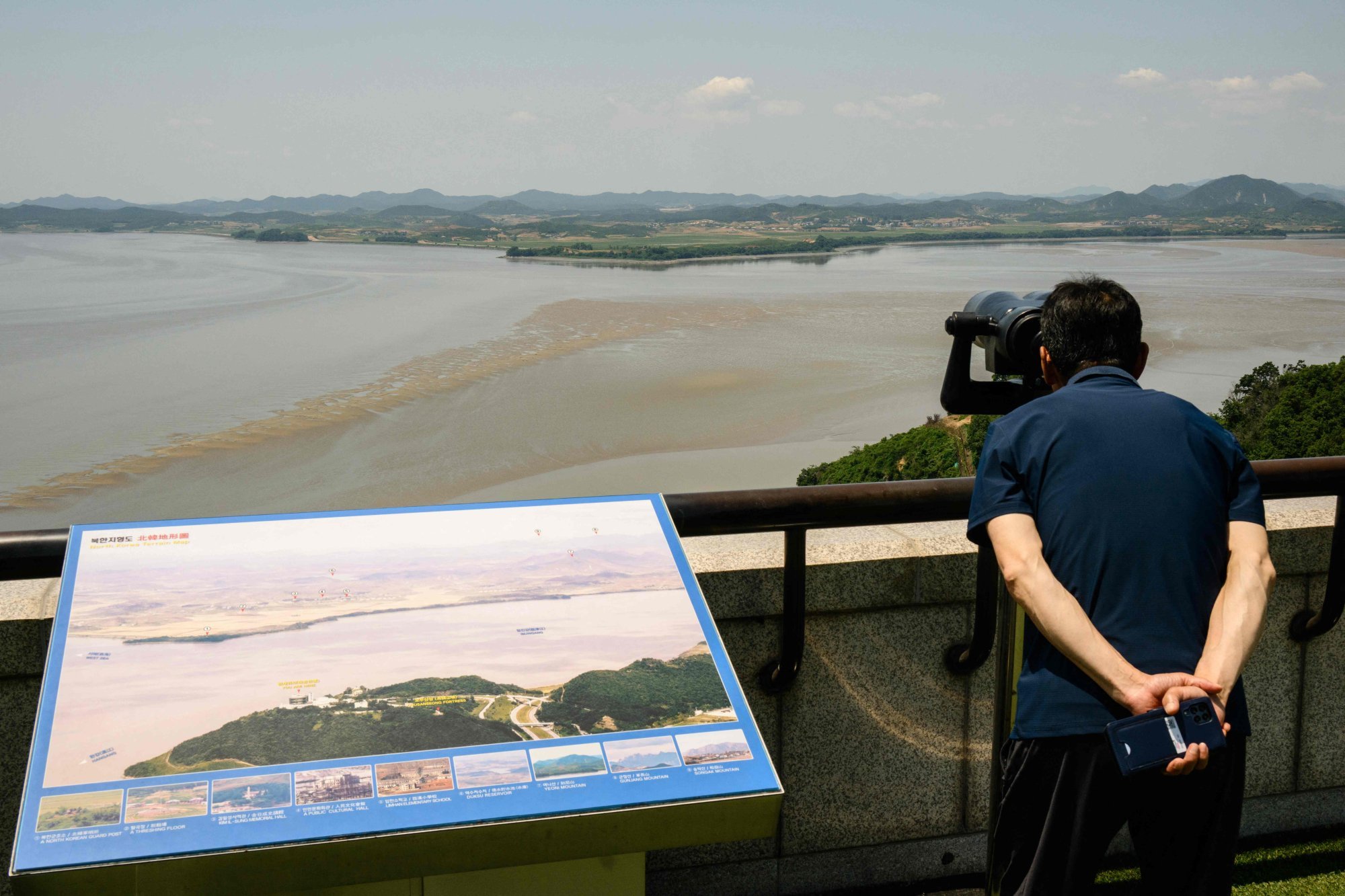 A visitor uses binoculars to watch the North Korean side of the demilitarised zone dividing the two Koreas, from South Korea’s Odusan Unification Observatory in Paju on June 12. Photo: AFP A visitor uses binoculars to watch the North Korean side of the demilitarised zone dividing the two Koreas, from South Korea’s Odusan Unification Observatory in Paju on June 12. Photo: AFP