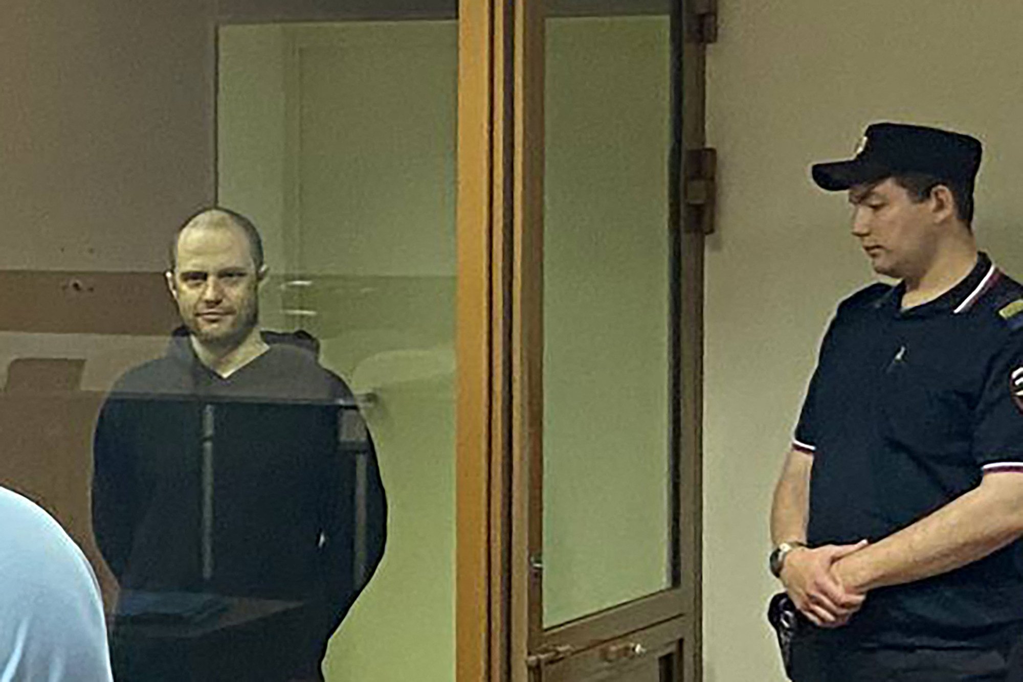 Photographer Grigory Skvortsov, left, during the verdict announcement in his treason trial in Perm, Russia on Thursday. Photo: Perm Regional Court / AFP