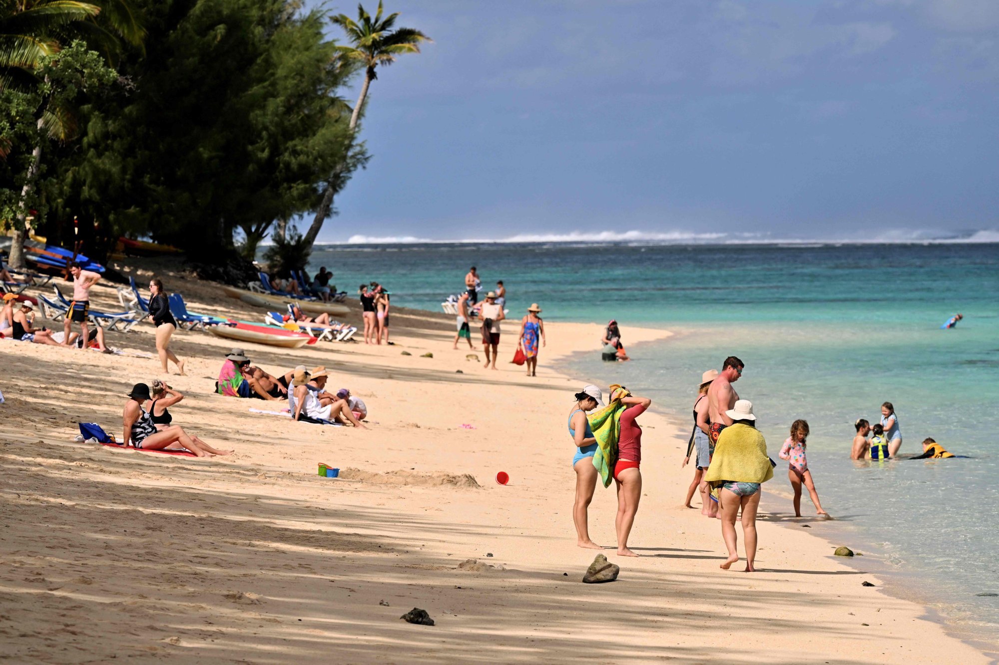 Tourists relax on a beach on Rarotonga, the largest island in the Cook Islands, on June 12. Photo: AFP