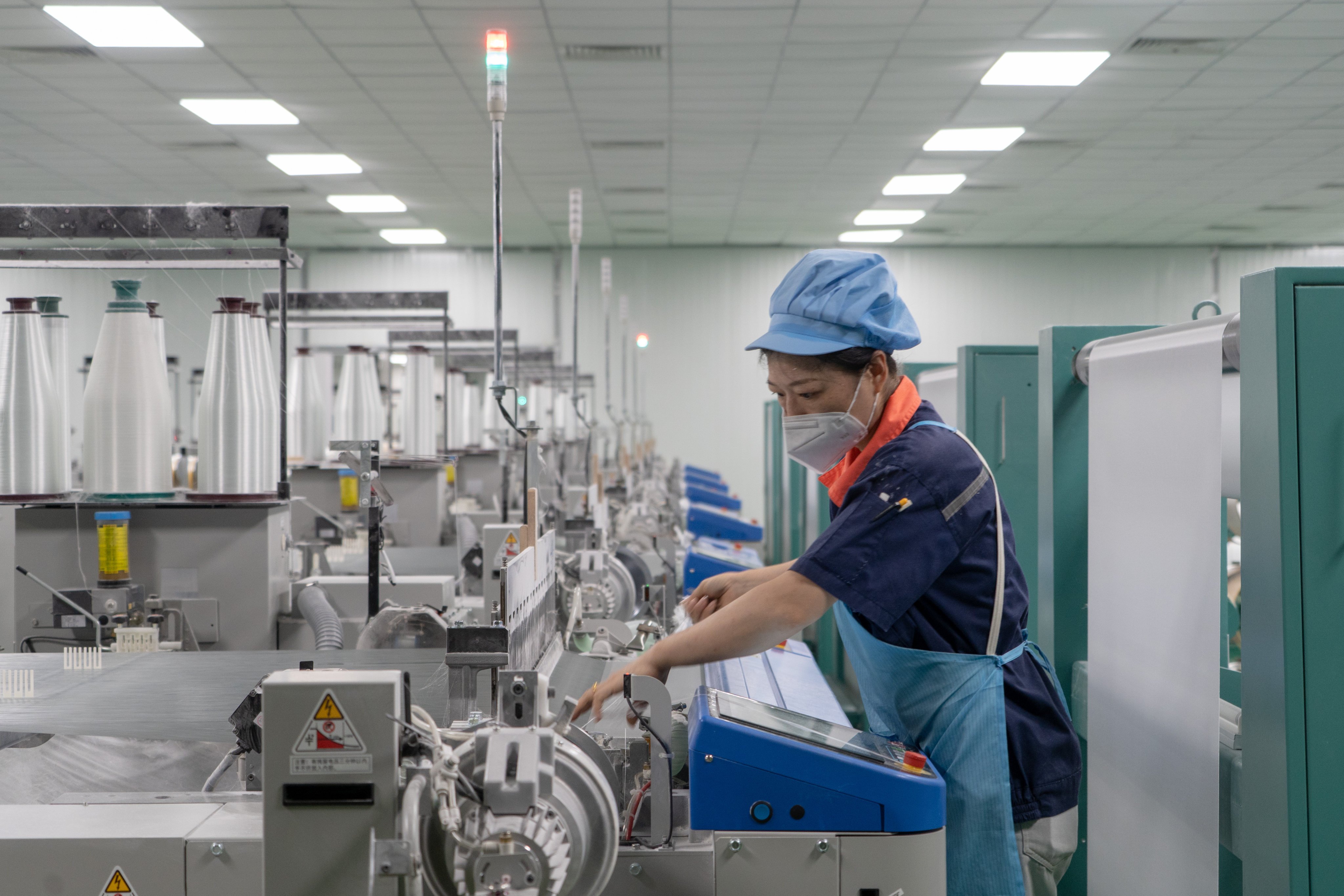 A worker handles machinery at a new-materials company in China’s Jiangxi province earlier this month. Many industrial companies saw their profits take a hit in May, according to official figures released on Friday. Photo: Xinhua