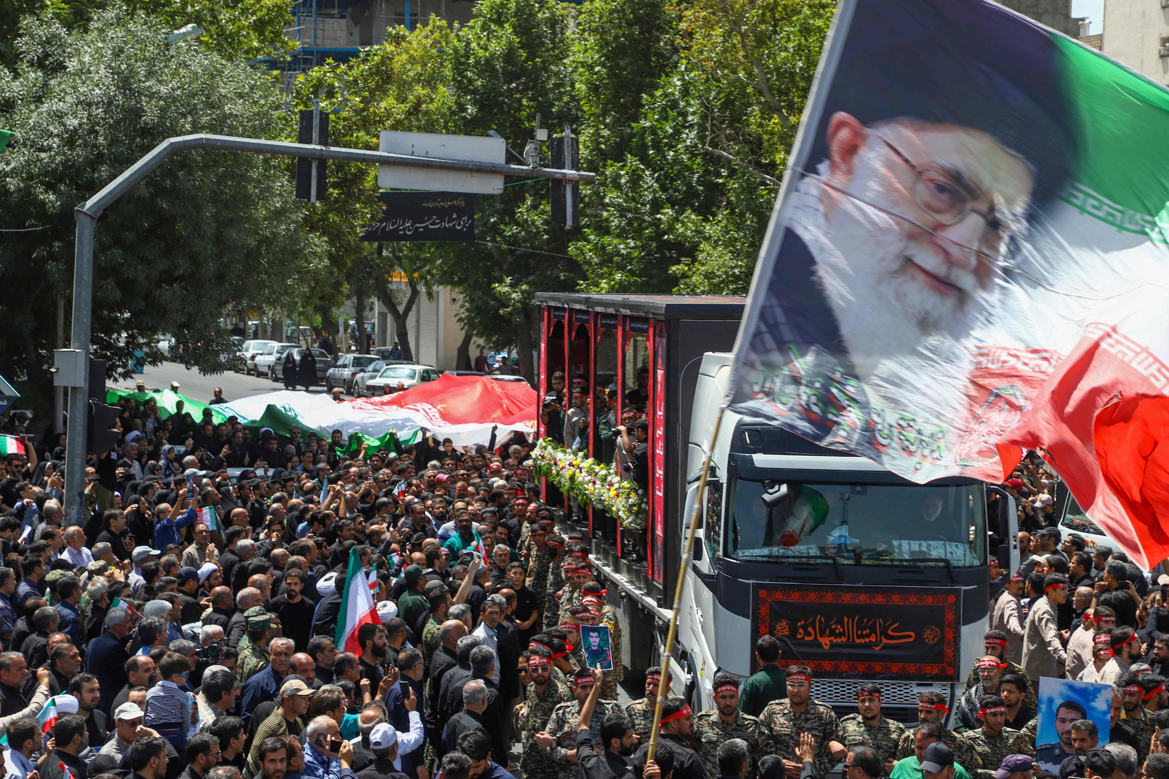 A flag with the portrait of Iran’s Supreme Leader Ayatollah Ali Khamenei is waved during Friday’s funeral procession of 15 people killed in Israeli strikes. Photo: ISNA/AFP