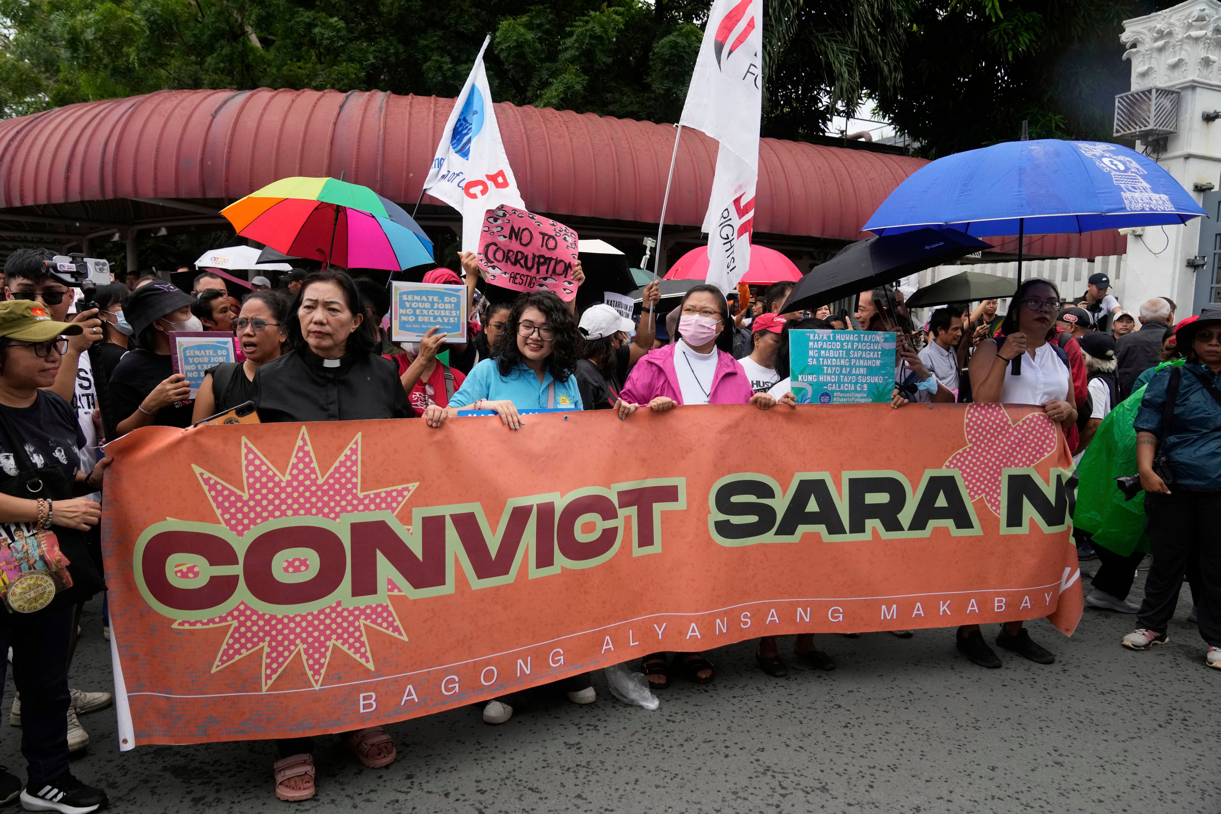 Protesters hold slogans during a rally to condemn the senate’s recent decision not to immediately bring Vice President Sara Duterte to an impeachment trial over corruption and other allegations, outside the Philippine Senate in Pasay, Philippines, on June 11. Photo: AP
