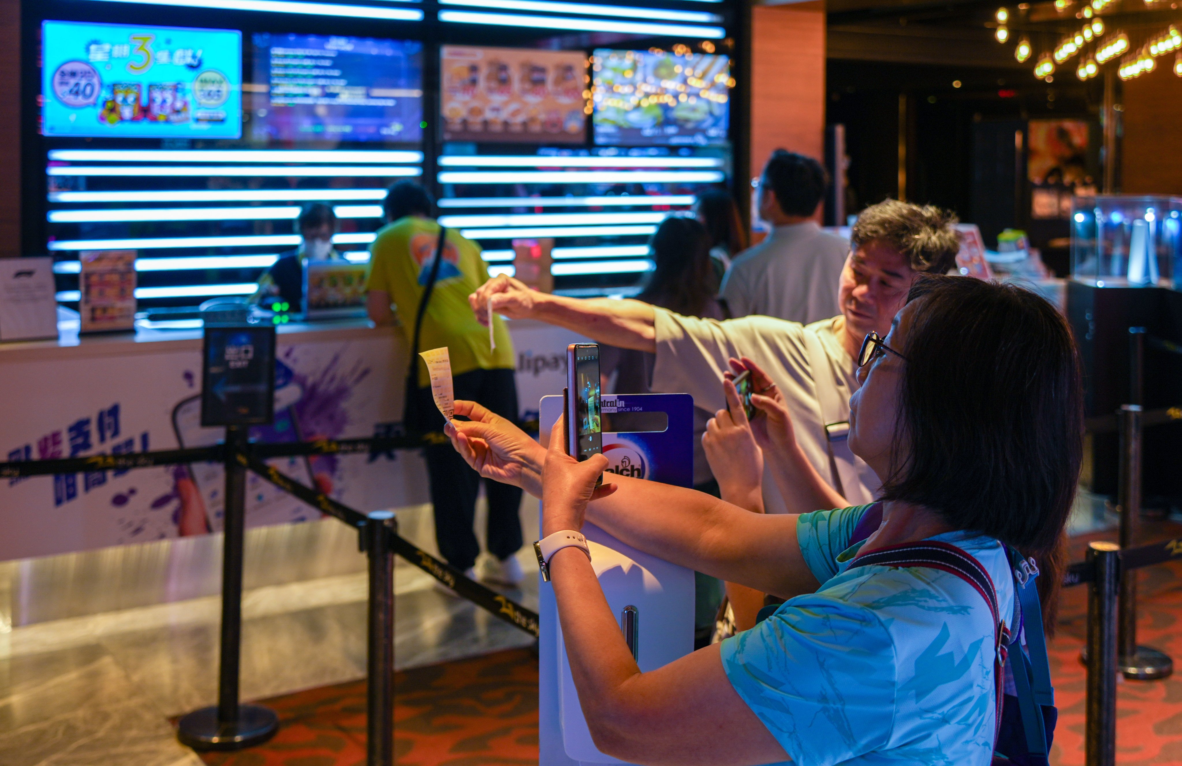 Moviegoers at The Sky at Olympian City on its last day in operation as Golden Harvest closed its four remaining cinemas. Photo: Eugene Lee