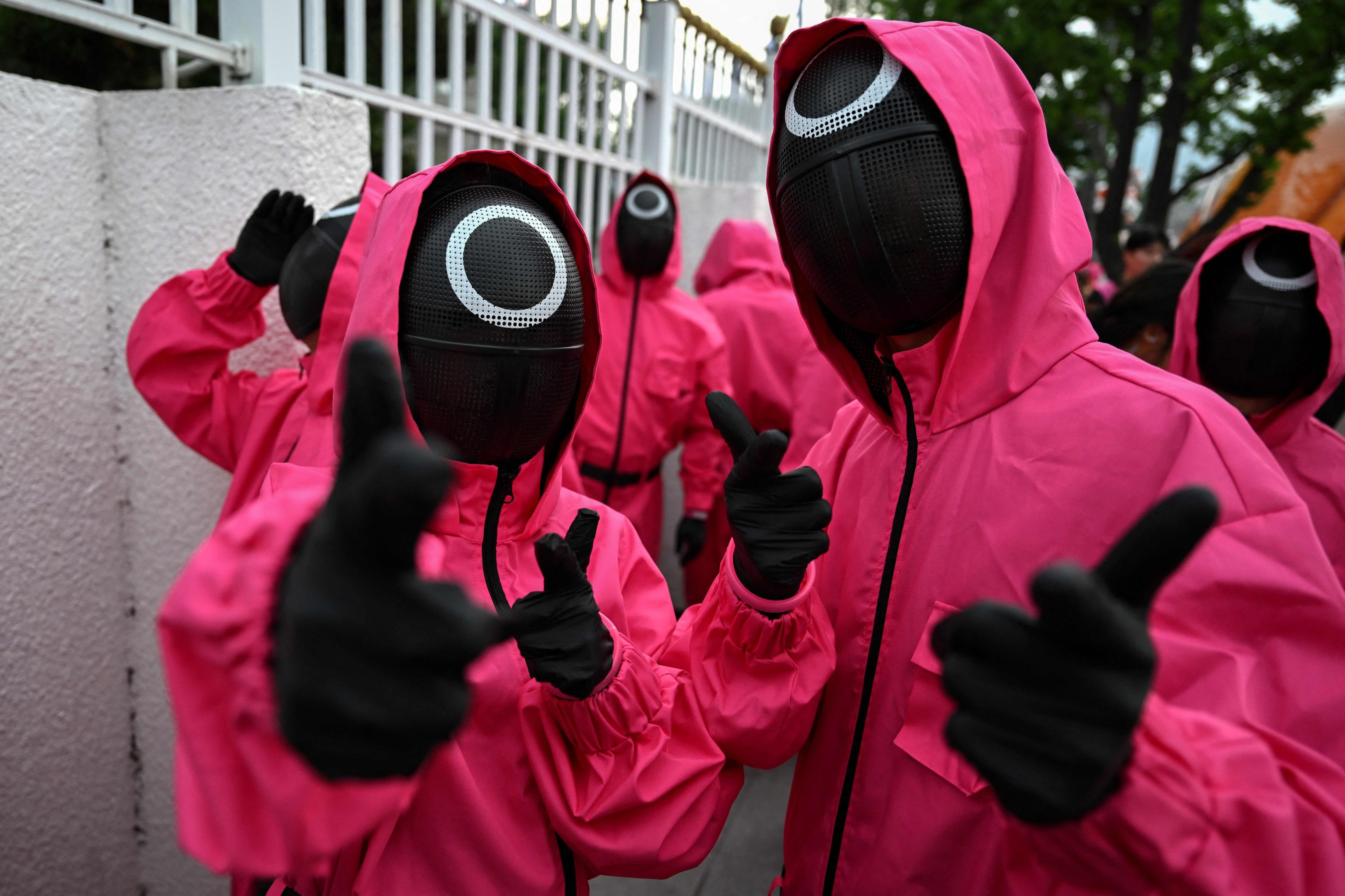 Performers dressed as the pink guards from “Squid Game” take part in a parade in Seoul on Saturday celebrating the final season of the Netflix series. Photo: AFP