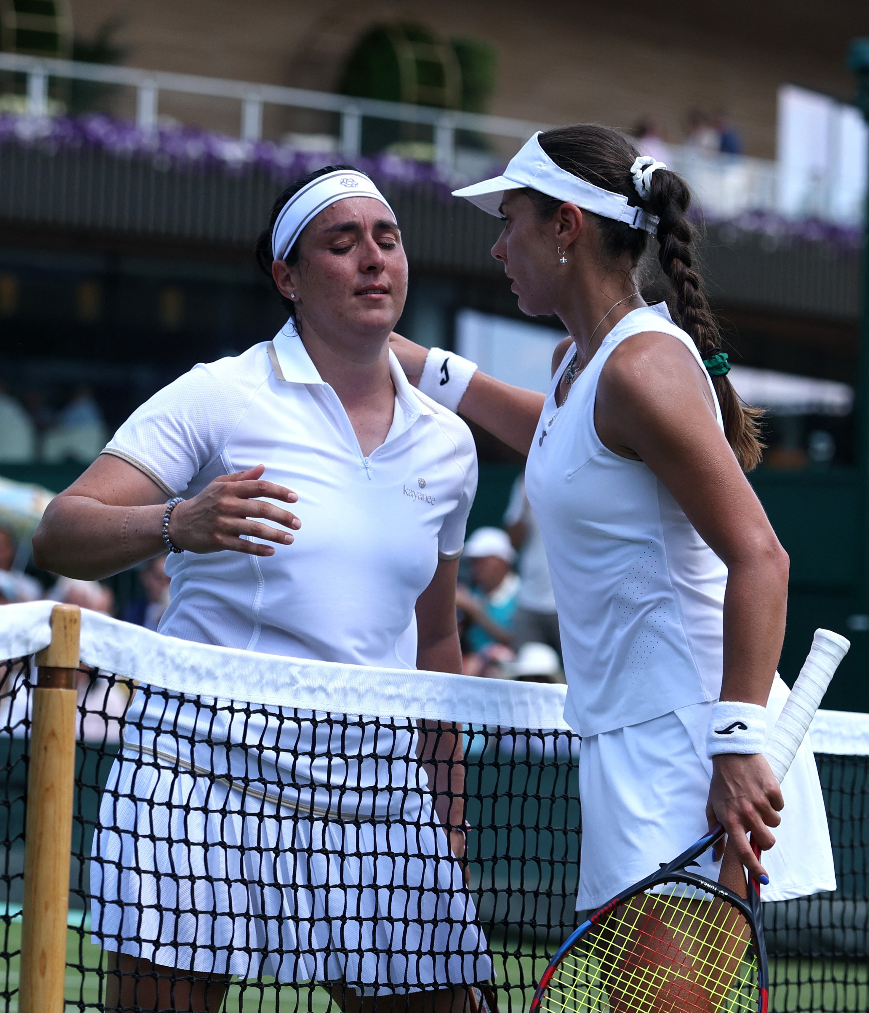 Bulgaria’s Viktoriya Tomova (right) consoles Tunisia’s Ons Jabeur, who was forced to retire hurt from their first-round match at Wimbledon on Monday. Photo: Reuters