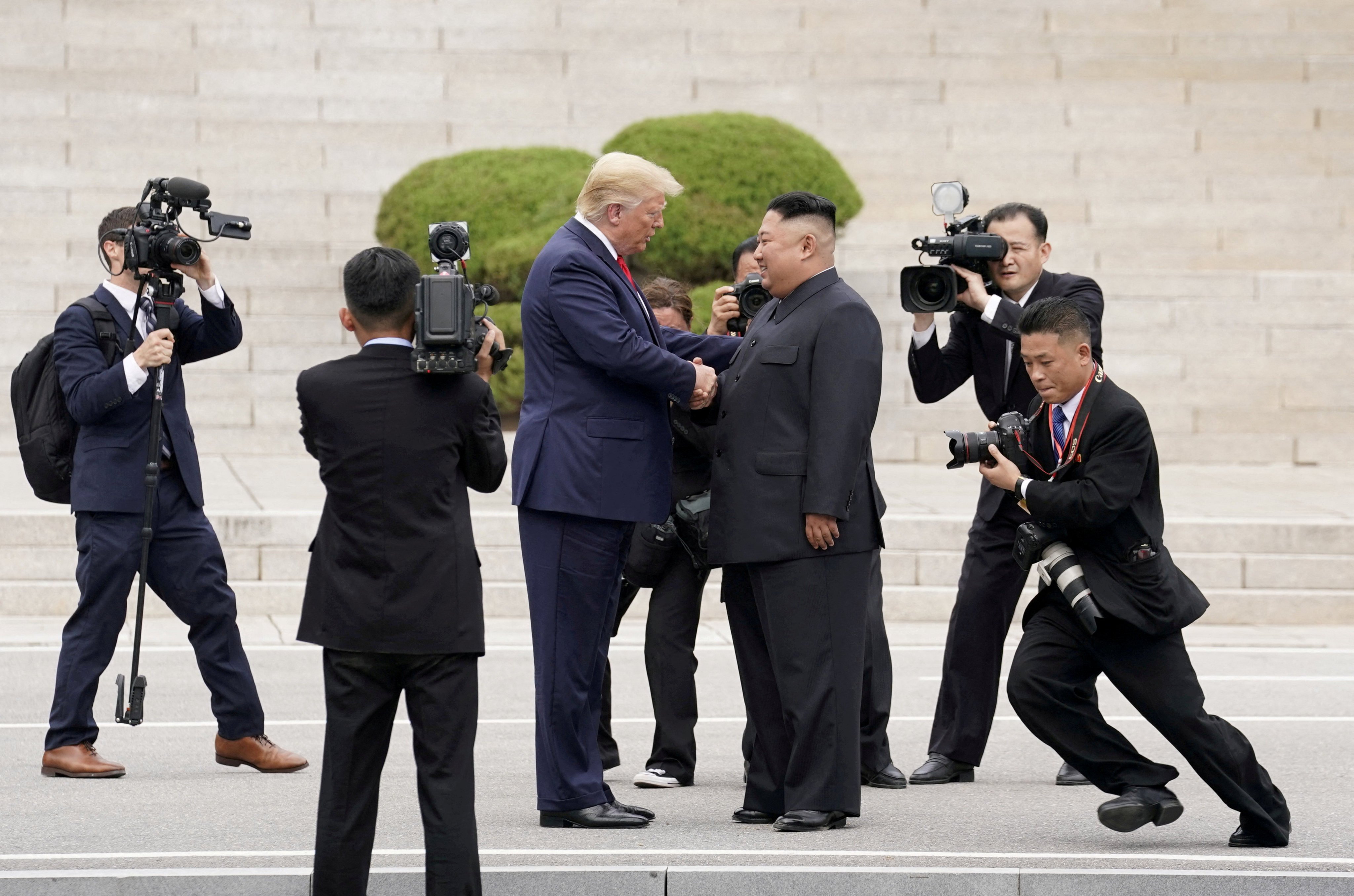 US President Donald Trump shakes hand with North Korean leader Kim Jong-un at the demilitarised zone separating the two Koreas during their third and final meeting in 2019. Photo: Reuters