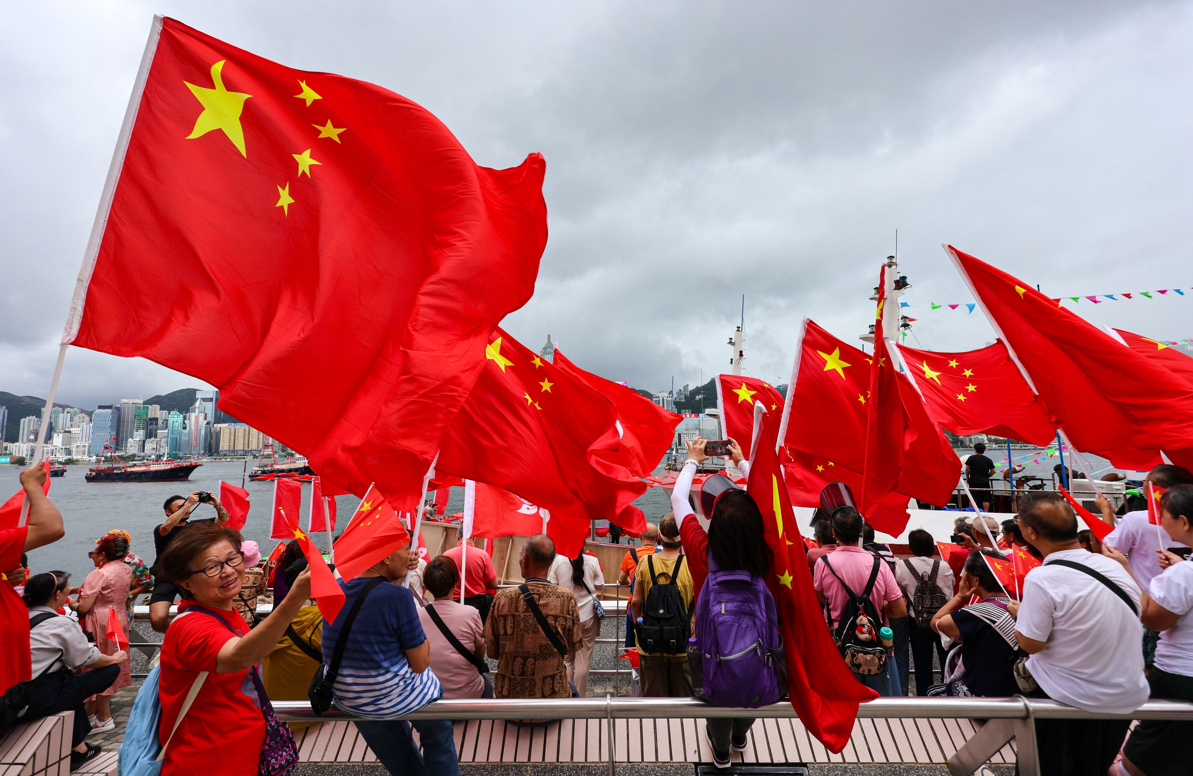 Spectators gather to watch a fishing boat parade to mark the July 1 anniversary. Photo: Jelly Tse