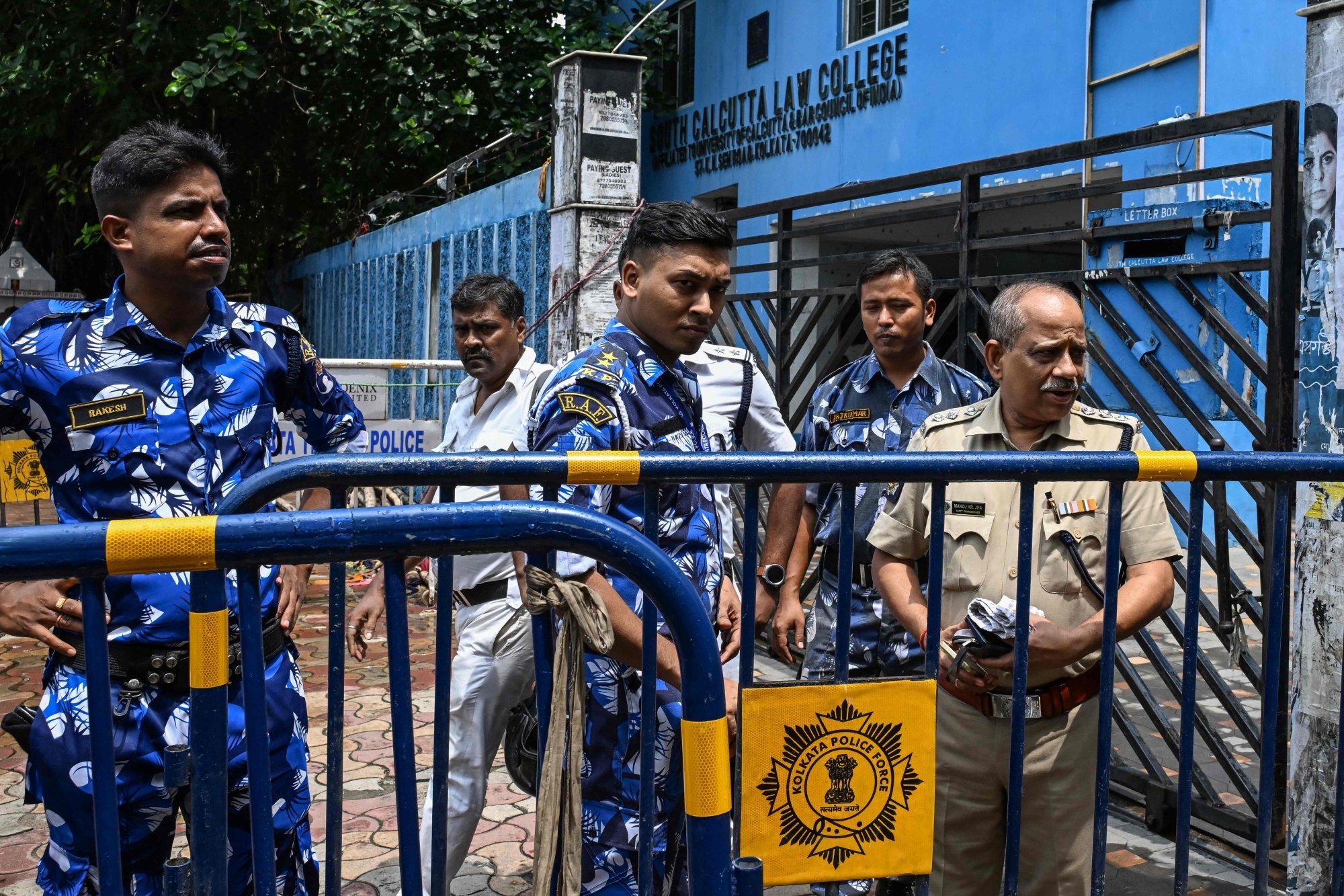 Security personnel stand guard outside the South Calcutta Law College in Kolkata during a protest on Monday after a student was allegedly raped. Photo: AFP