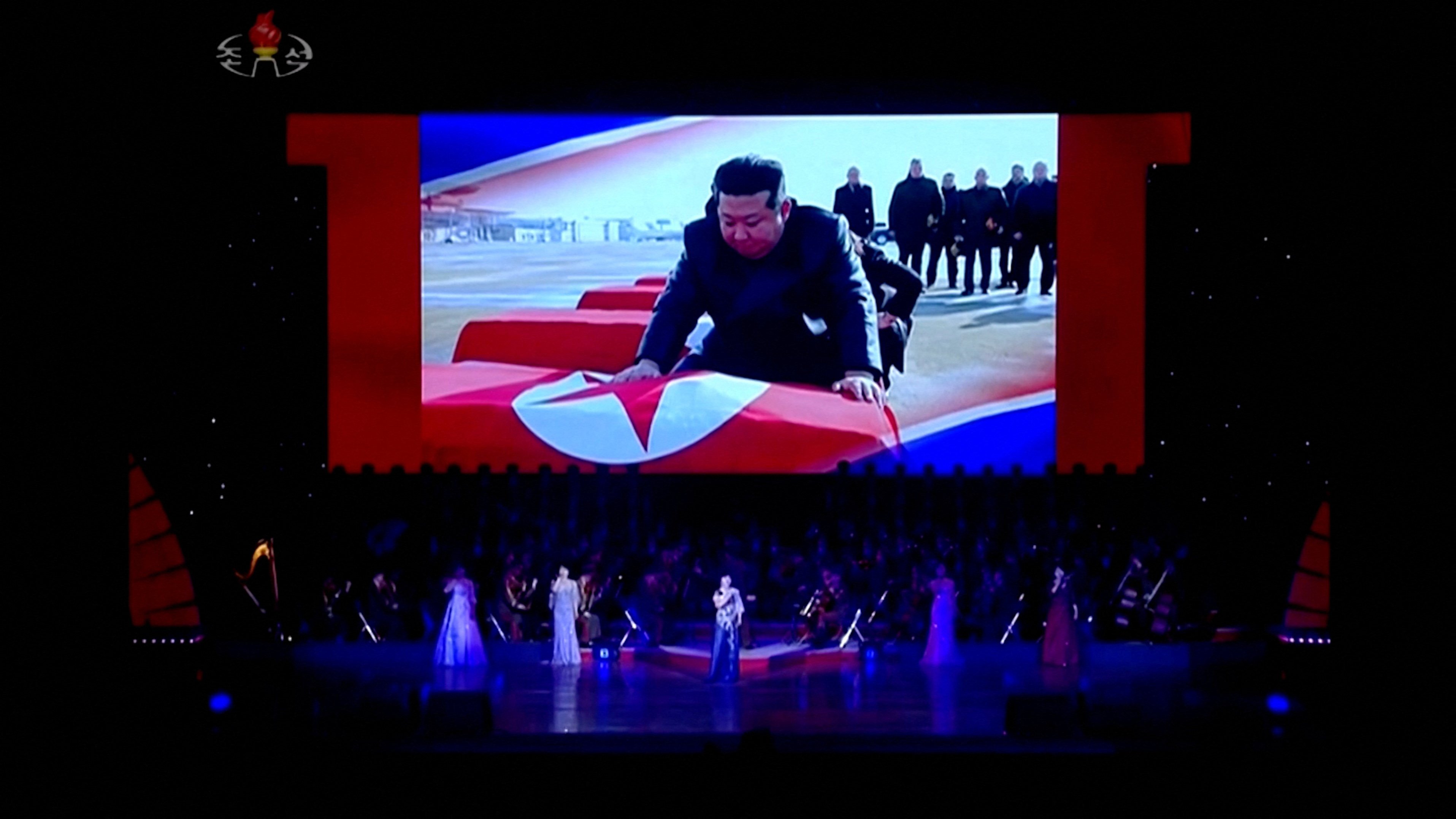 Footage showing North Korean leader Kim Jong-un draping coffins with the North Korean flag is displayed on a screen in Pyongyang during a cultural performance on Sunday. Photo: Korean Central Television / Reuters