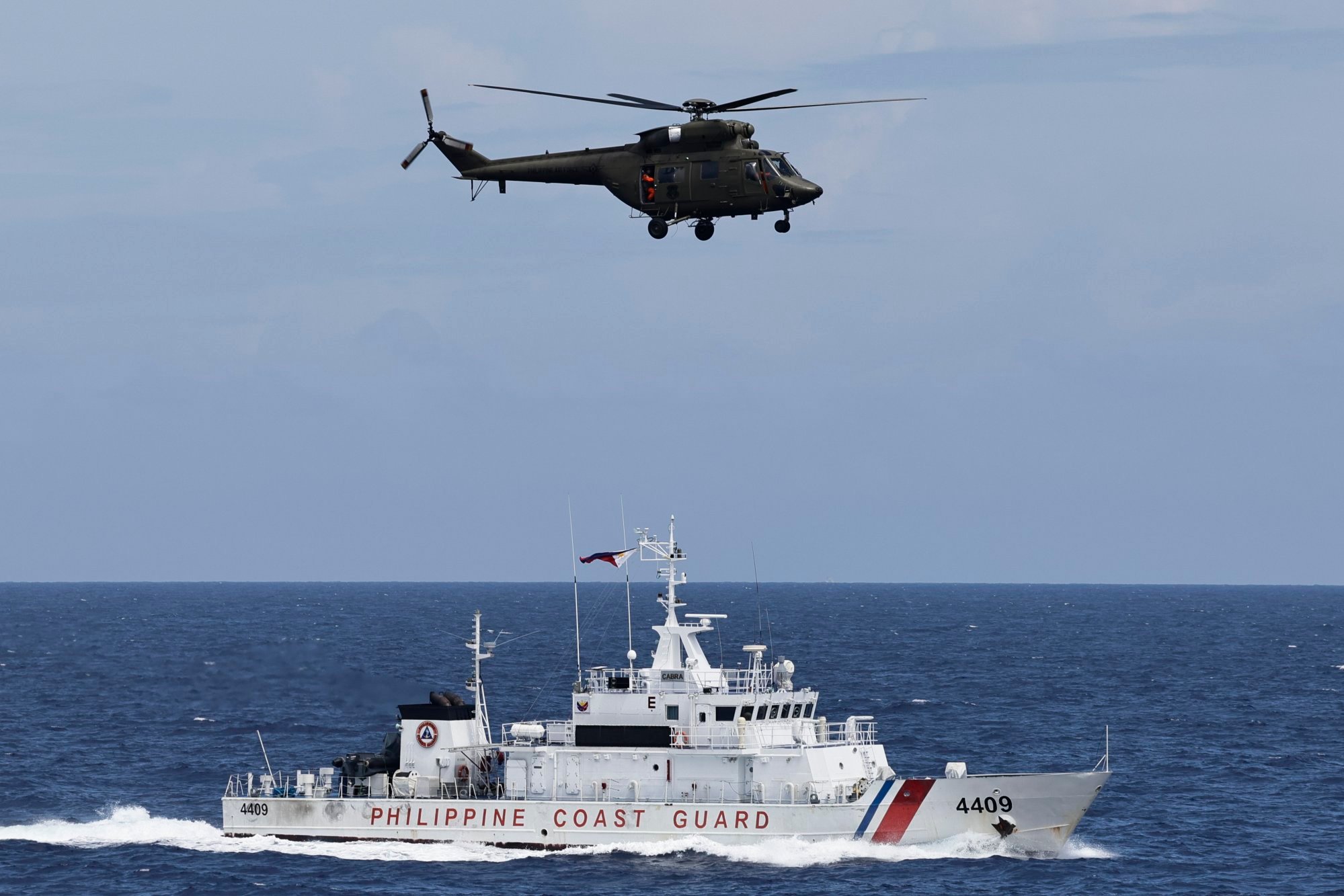 A Philippine Air Force helicopter passes above Philippine Coast Guard vessel BRP Cabra during a joint maritime activity with the US in disputed waters of the South China Sea in June. Photo: EPA-EFE A Philippine Air Force helicopter passes above Philippine Coast Guard vessel BRP Cabra during a joint maritime activity with the US in disputed waters of the South China Sea in June. Photo: EPA-EFE