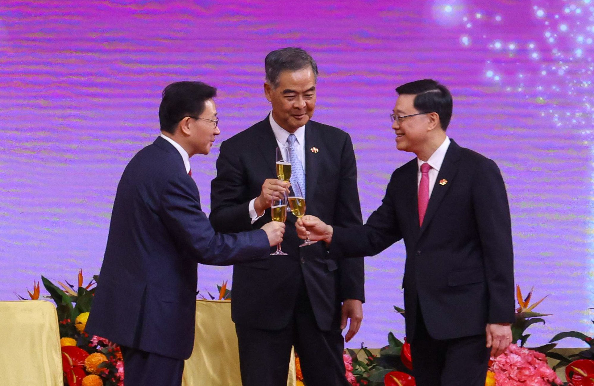 John Lee (right) celebrates with Zhou Ji (left), the director of Beijing’s liaison office in Hong Kong, and former city leader Leung Chun-ying. Photo: Nora Tam