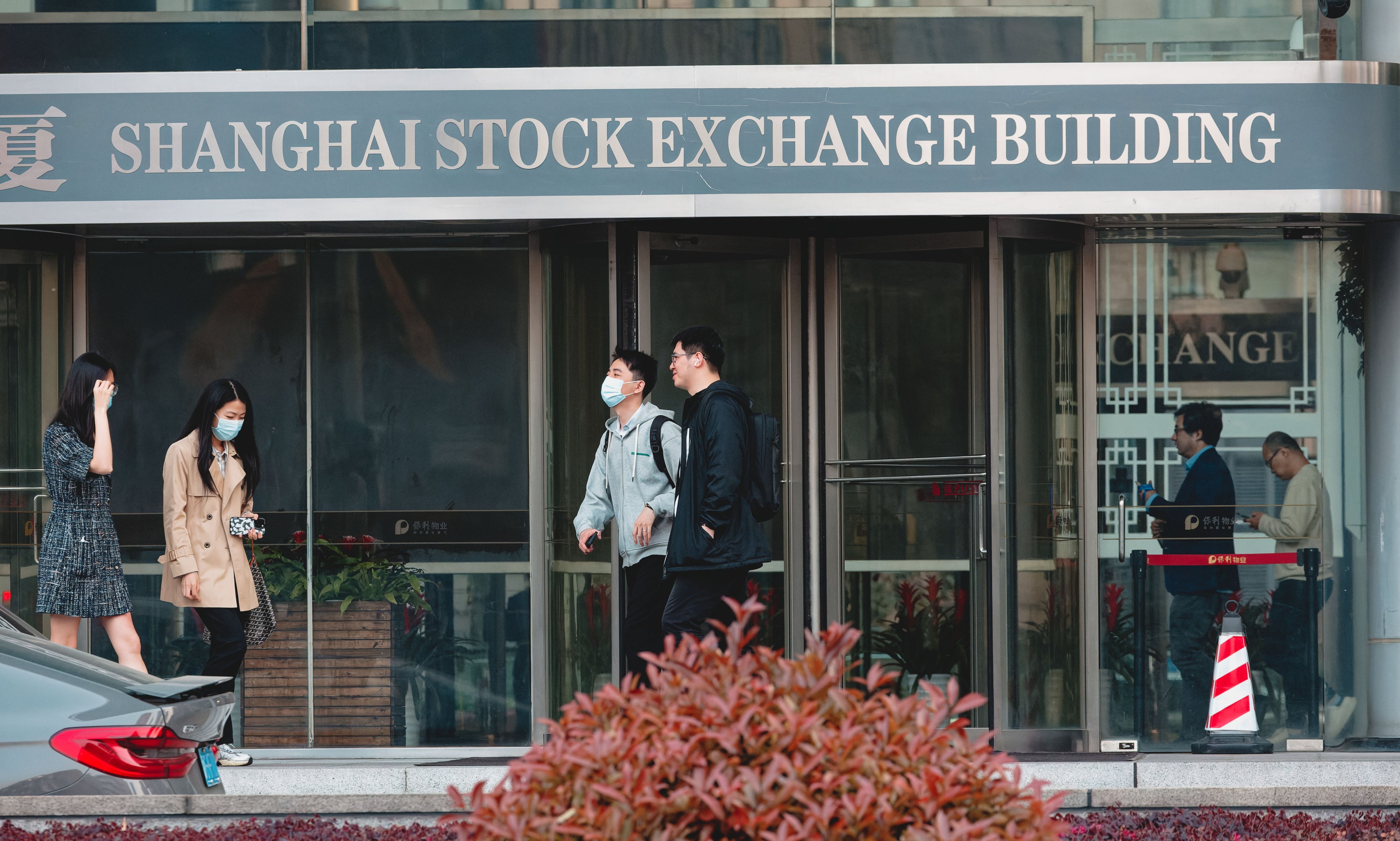 People pass the Shanghai Stock Exchange. Photo: EPA-EFE