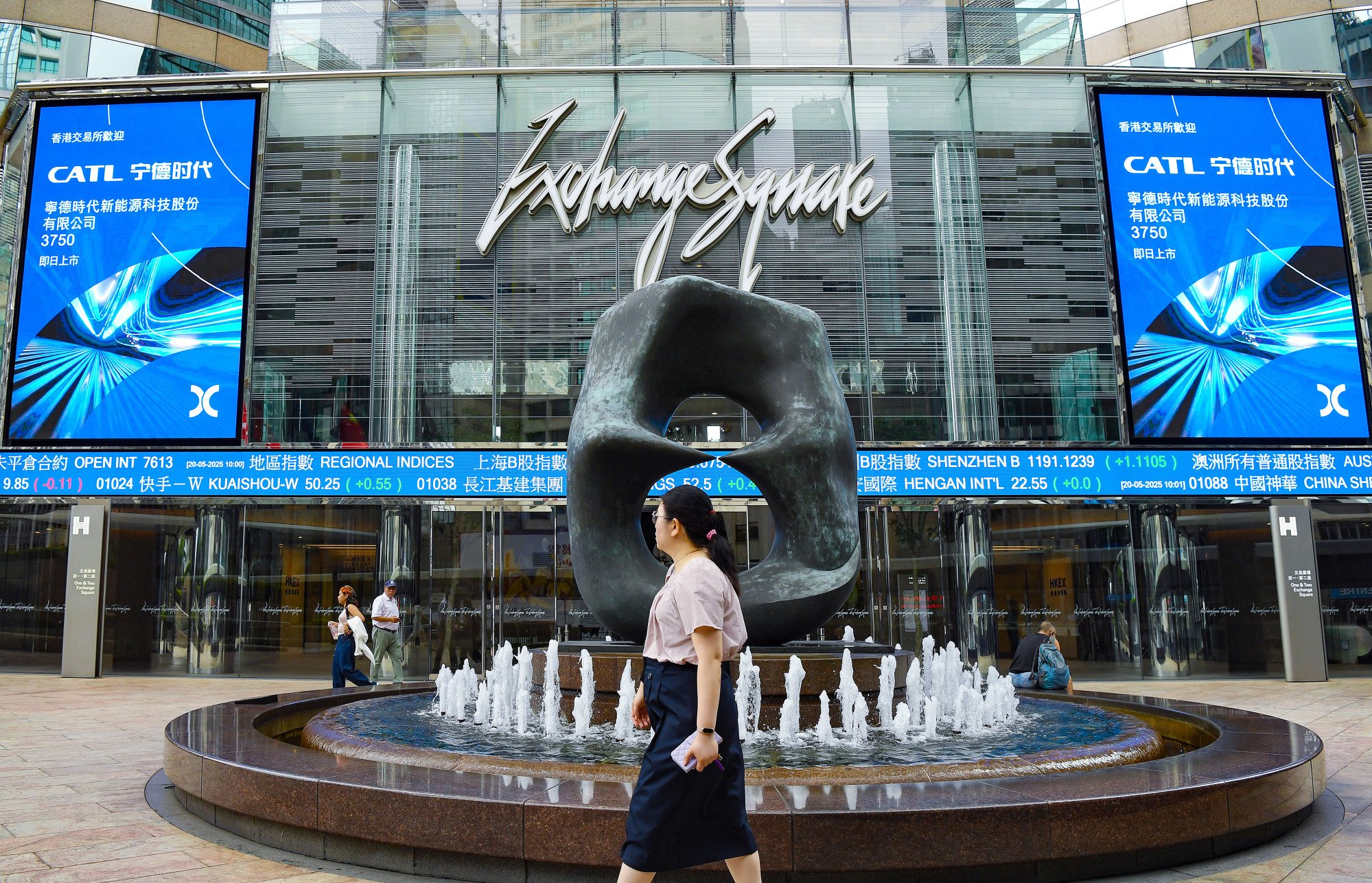 People pass Exchange Square, the office complex housing the headquarters of stock-exchange operator Hong Kong Exchanges and Clearing, on May 20, 2025. Photo: Xinhua