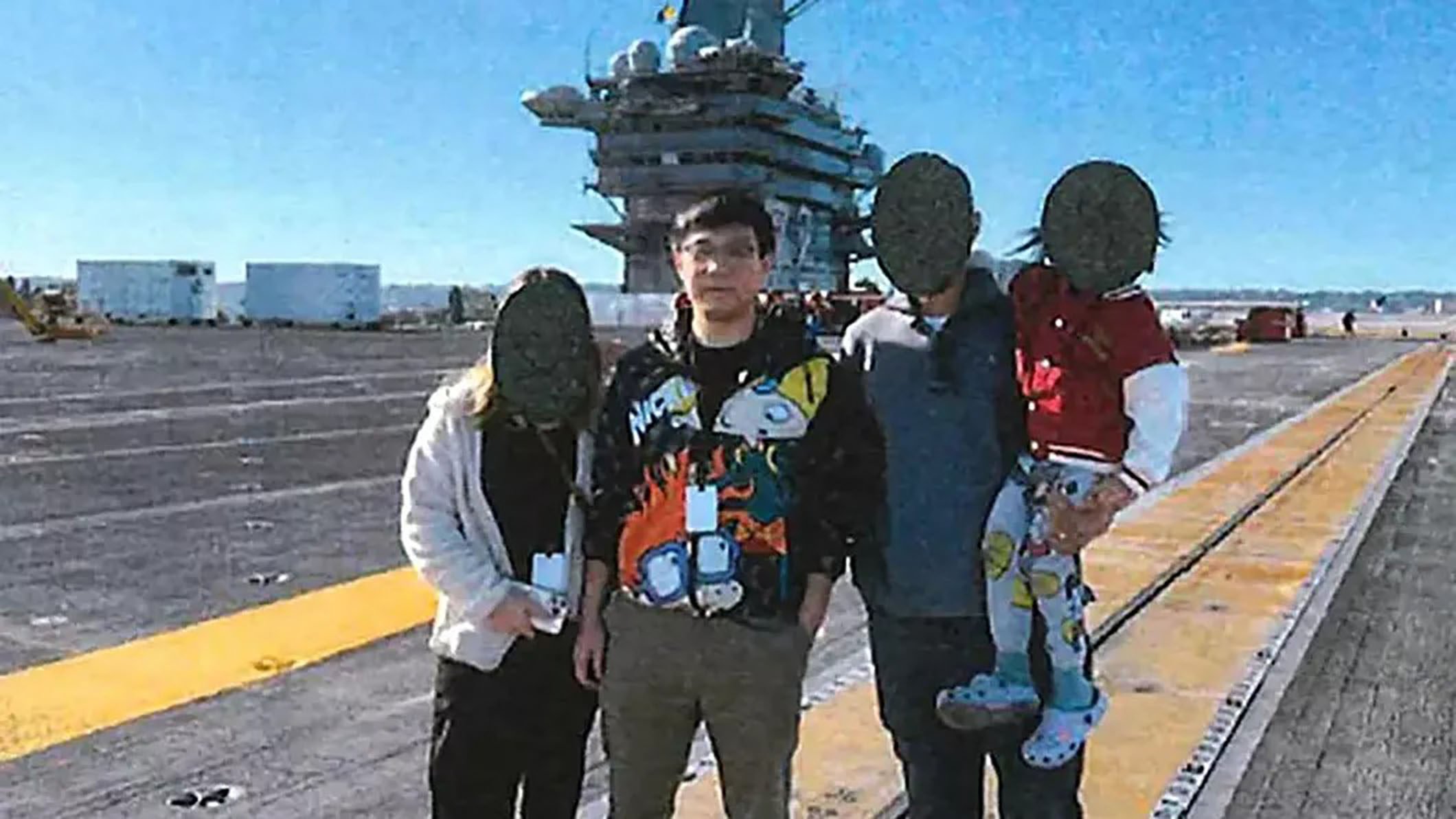 Yuance Chen (second from left) was photographed on the deck of the USS Abraham Lincoln in January 2025, the criminal complaint says. Photo: US District Court for the Northern District of California