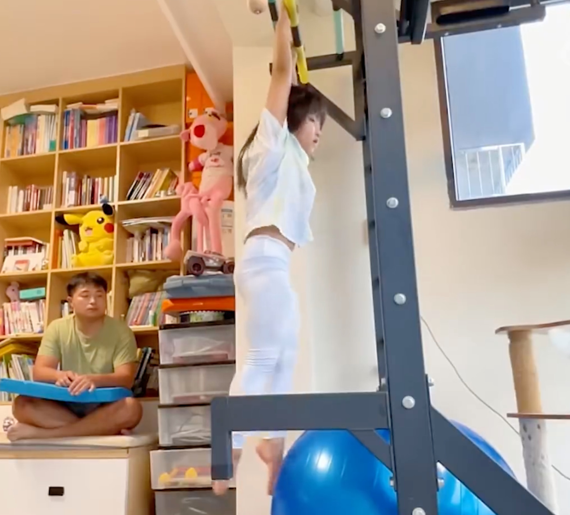 The youngster mimics the backstroke by using fitness equipment her father installed at home to build up the muscles she needs in the pool. Photo: handout