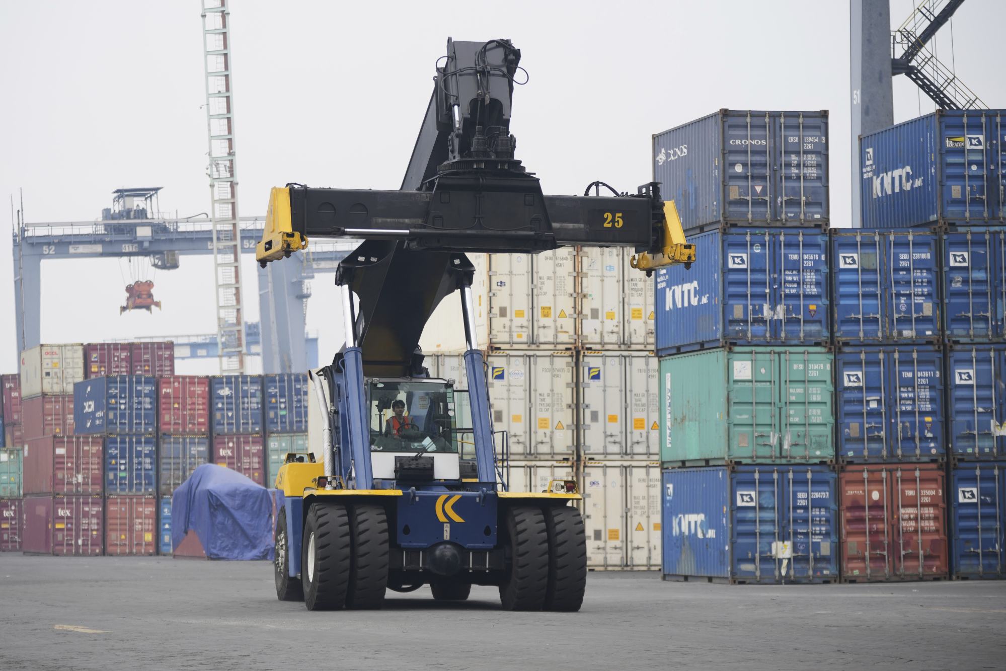 A heavy machine drives past shipping containers stacked at Tanjung Prior Port in Jakarta in April. Indonesia is trying to avert a 32 per cent tariff imposed by the US. Photo: AP