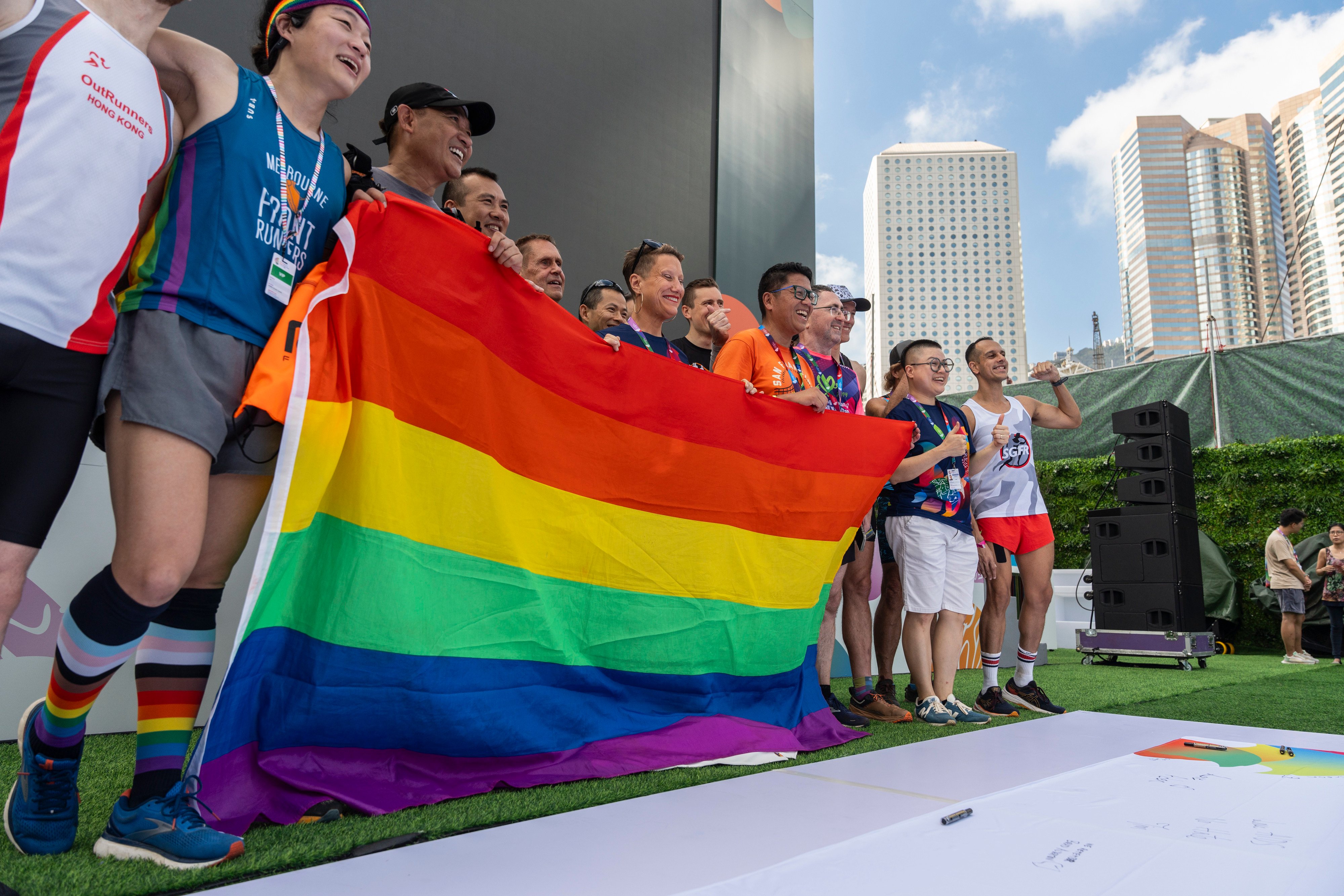 Participants hold the rainbow flag at the AIDS Quilt Memorial Ceremony, ahead of the Gay Games in Hong Kong in 2023. The city has proposed a system that will recognise same-sex partnerships and offer them some rights. Photo: AP
