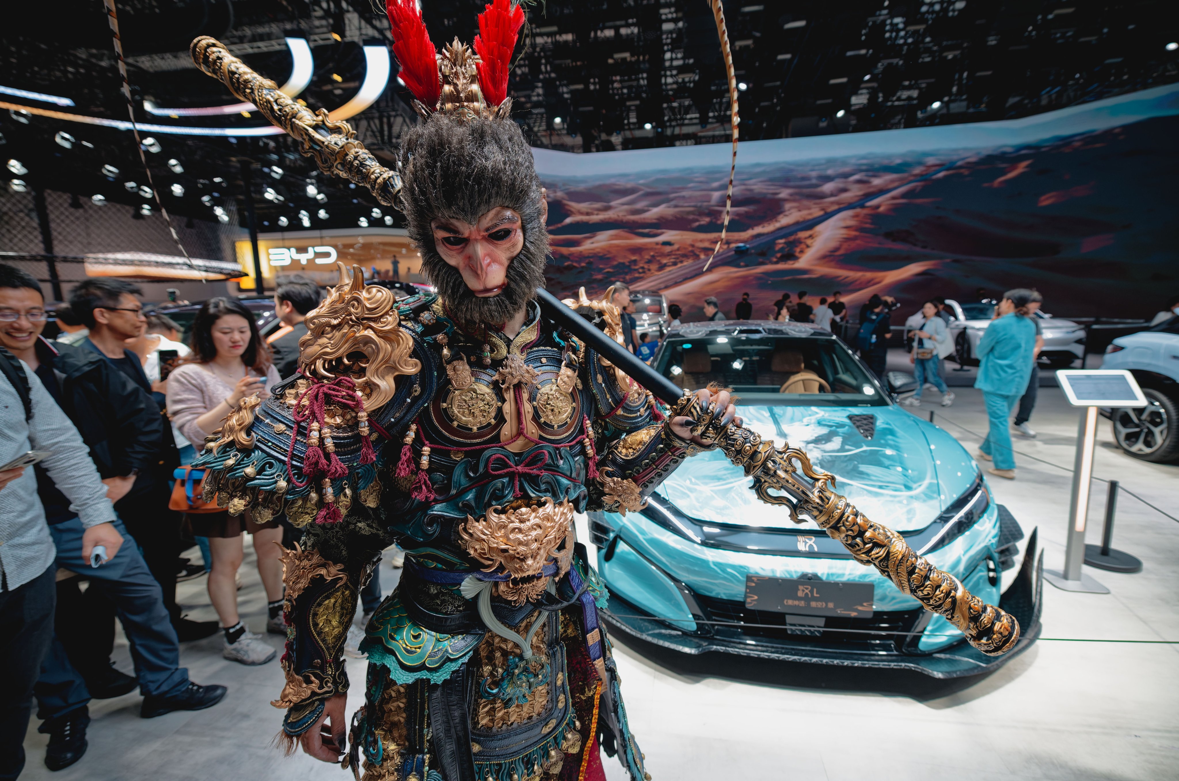 A costumed actor poses in front of a car at the BYD booth during the Shanghai Auto show in in China on April 25. Photo: EPA-EFE