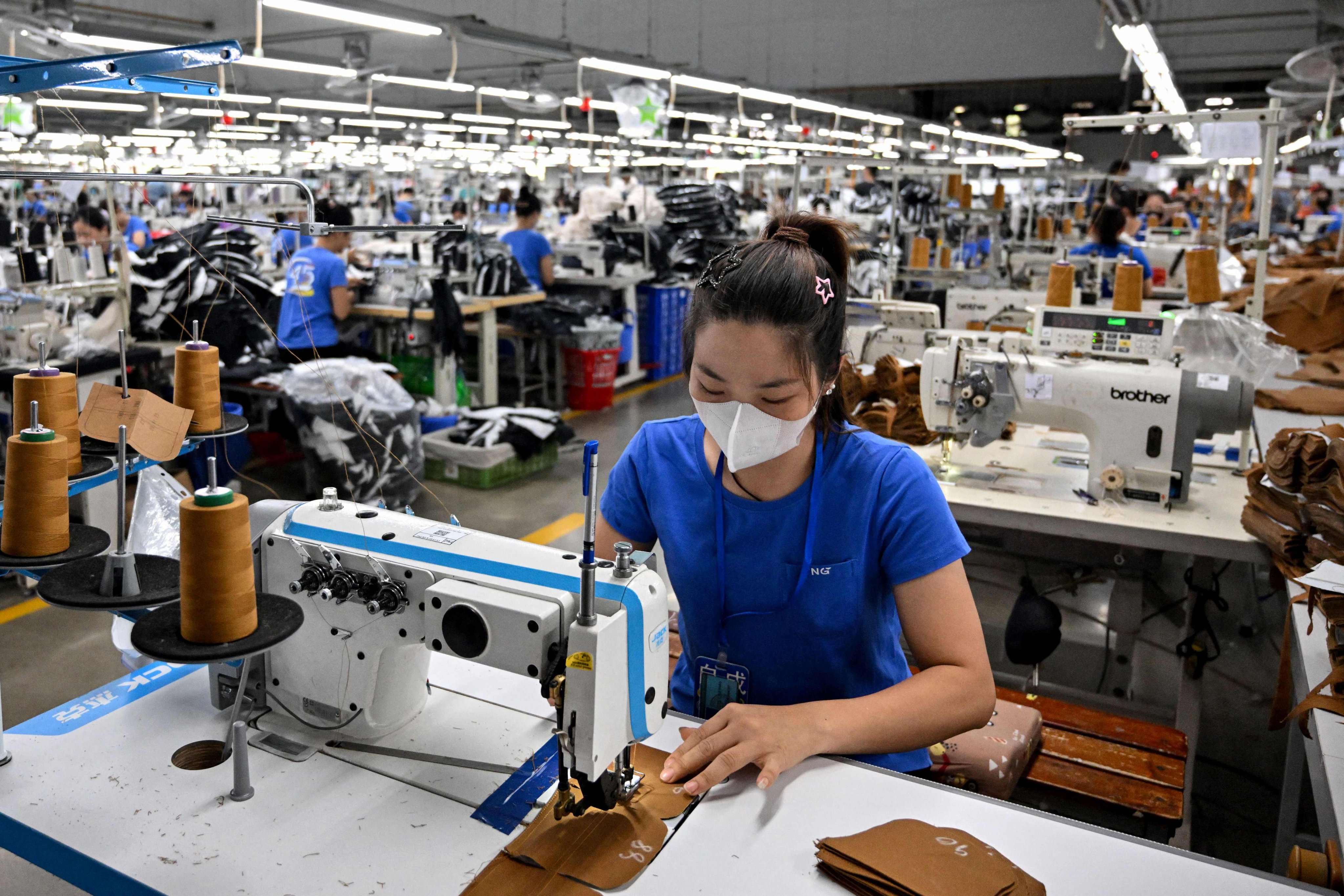 A worker stitches clothes at a garment factory in Vietnam. Vietnam has agreed a trade deal with the United States, which will lower US tariffs on the country’s goods to 20 per cent. Photo: AFP