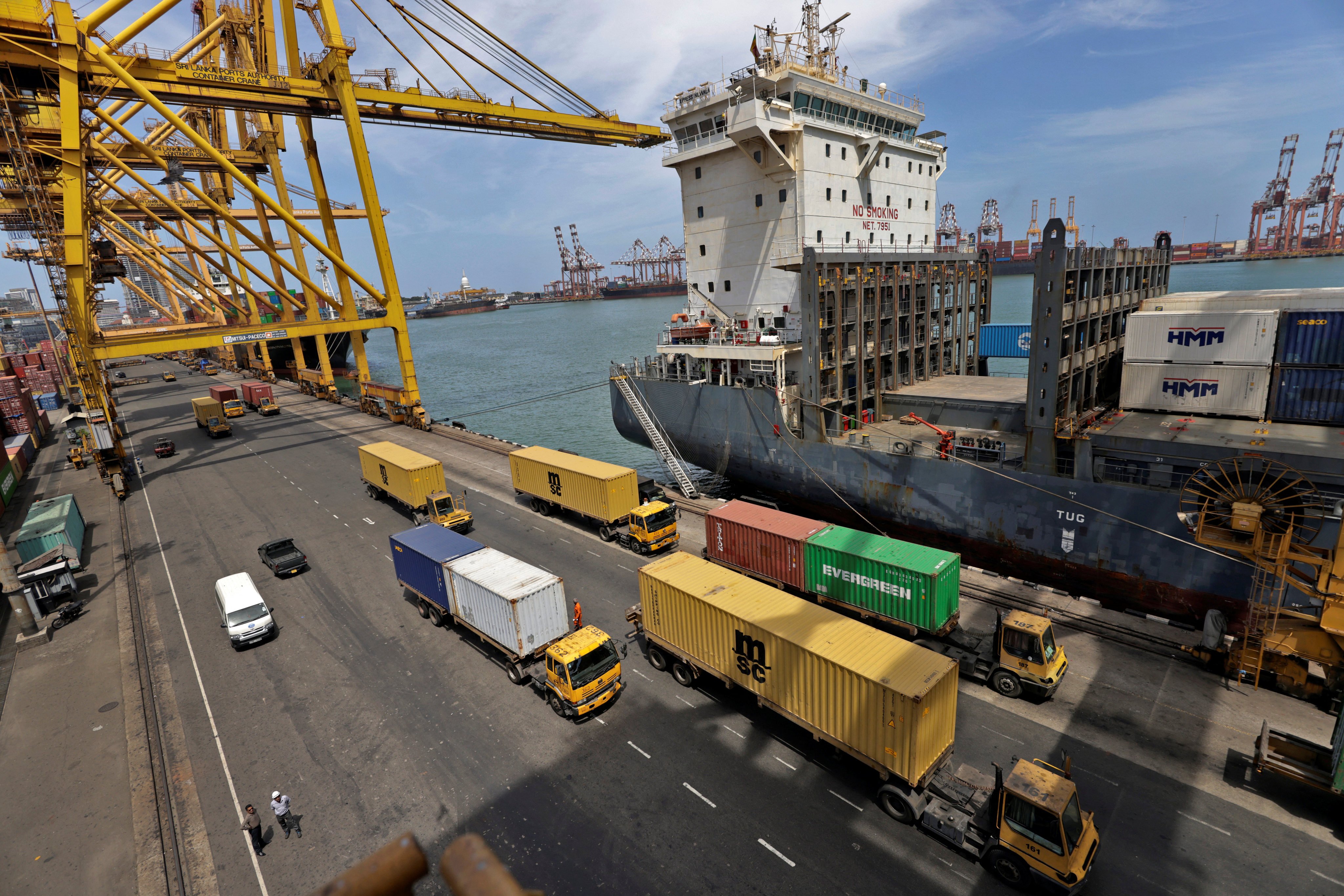 Trucks drive past shipping containers at the main port in Colombo, Sri Lanka. Colombo Dockyard is located within the port. Photo: Reuters