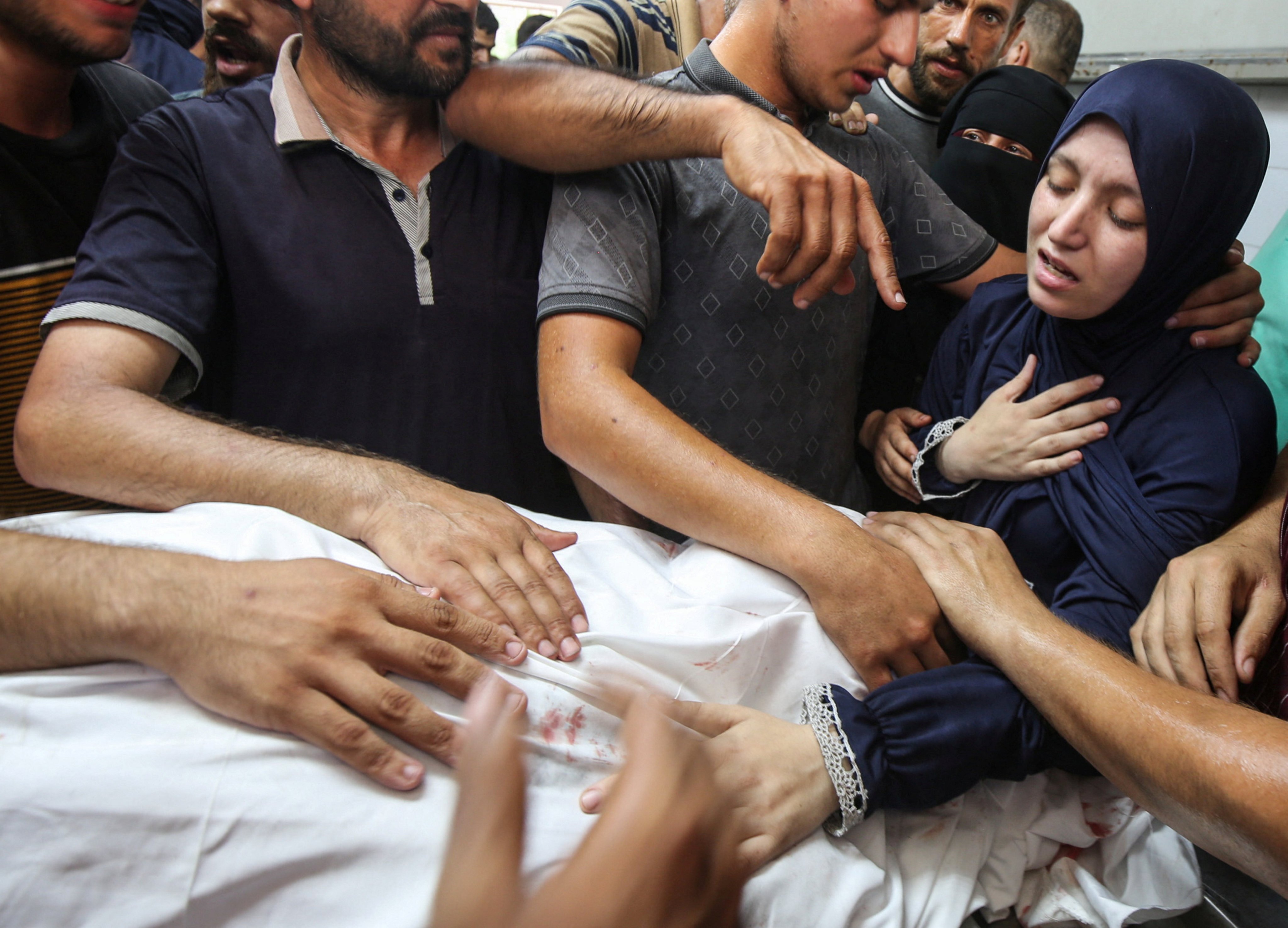 Palestinians mourn Dr Marwan Al-Sultan and his family, who were killed in an Israeli strike on Wednesday. Photo: Reuter