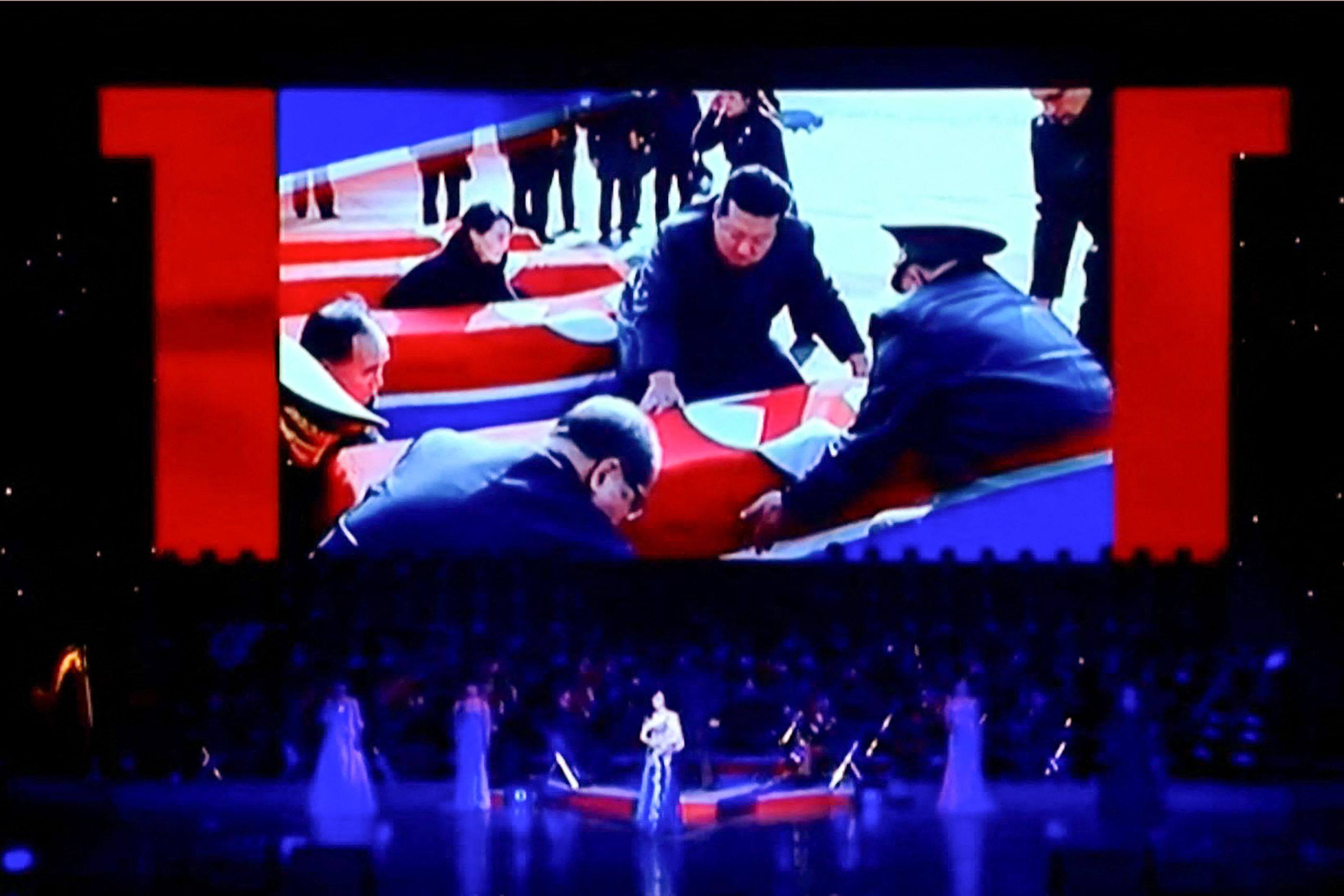 A screen displays North Korea’s leader Kim Jong-un looking at coffins during a performance attended by Kim and Russian Minister of Culture Olga Lyubimova in Pyongyang. Photo: Korean Central Television/AFP
