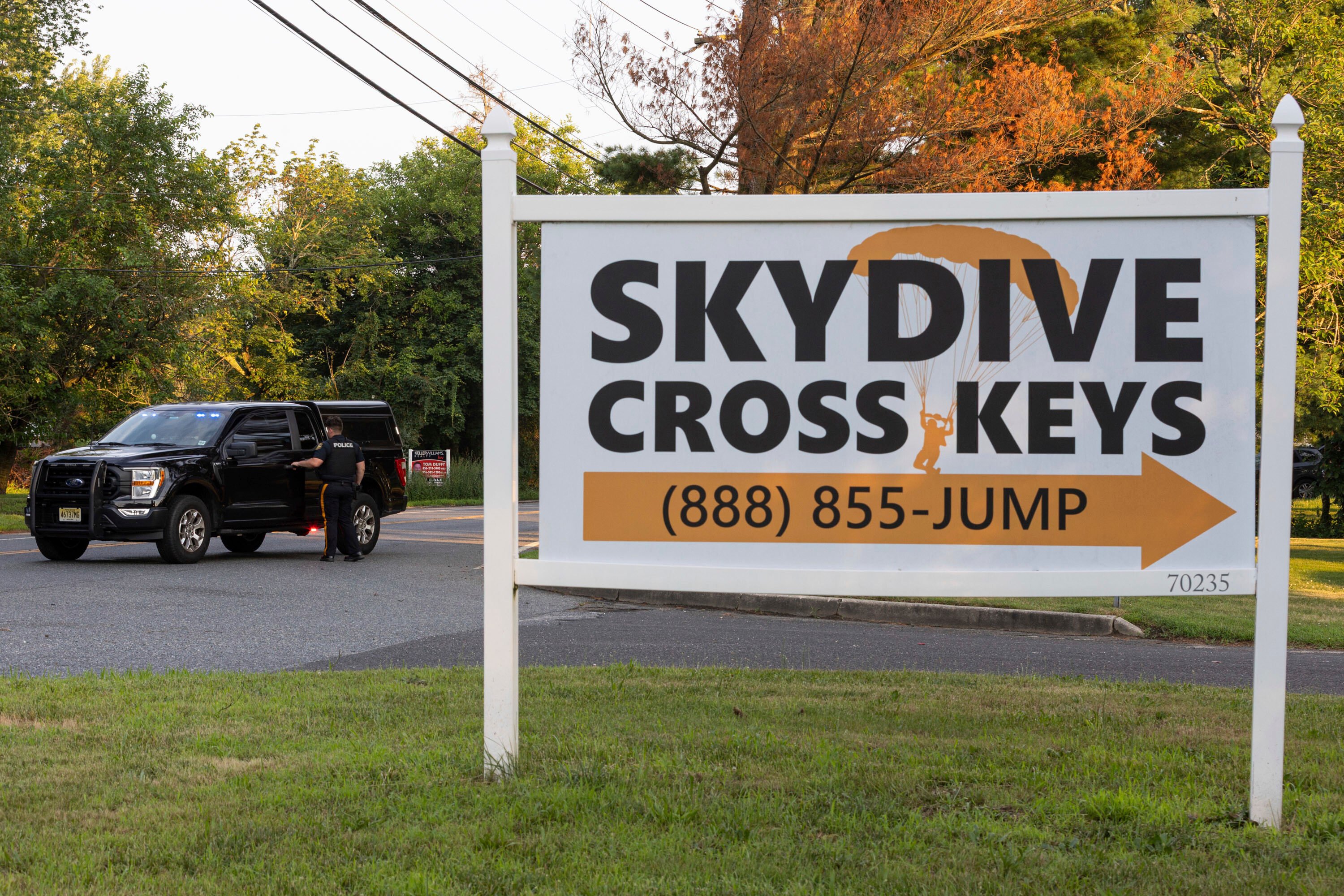 New Jersey state police direct traffic near Cross Keys Airport in Gloucester County after a skydiving aircraft went off the end of a runway and crashed into the woods on Wednesday. Photo: via AP