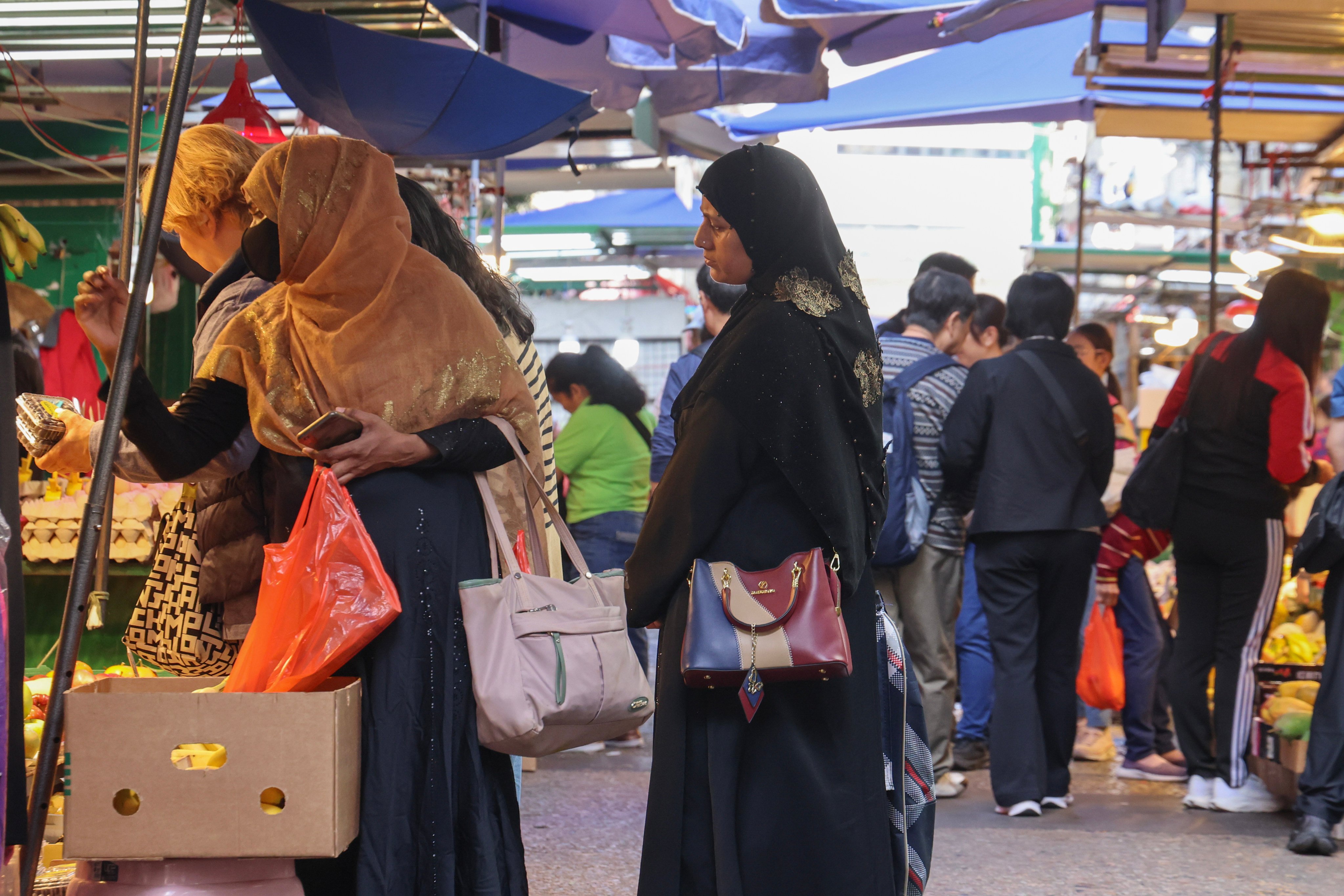 Women wearing headscarves shop at a market in Yau Ma Tei on February 28. Photo: Jelly Tse