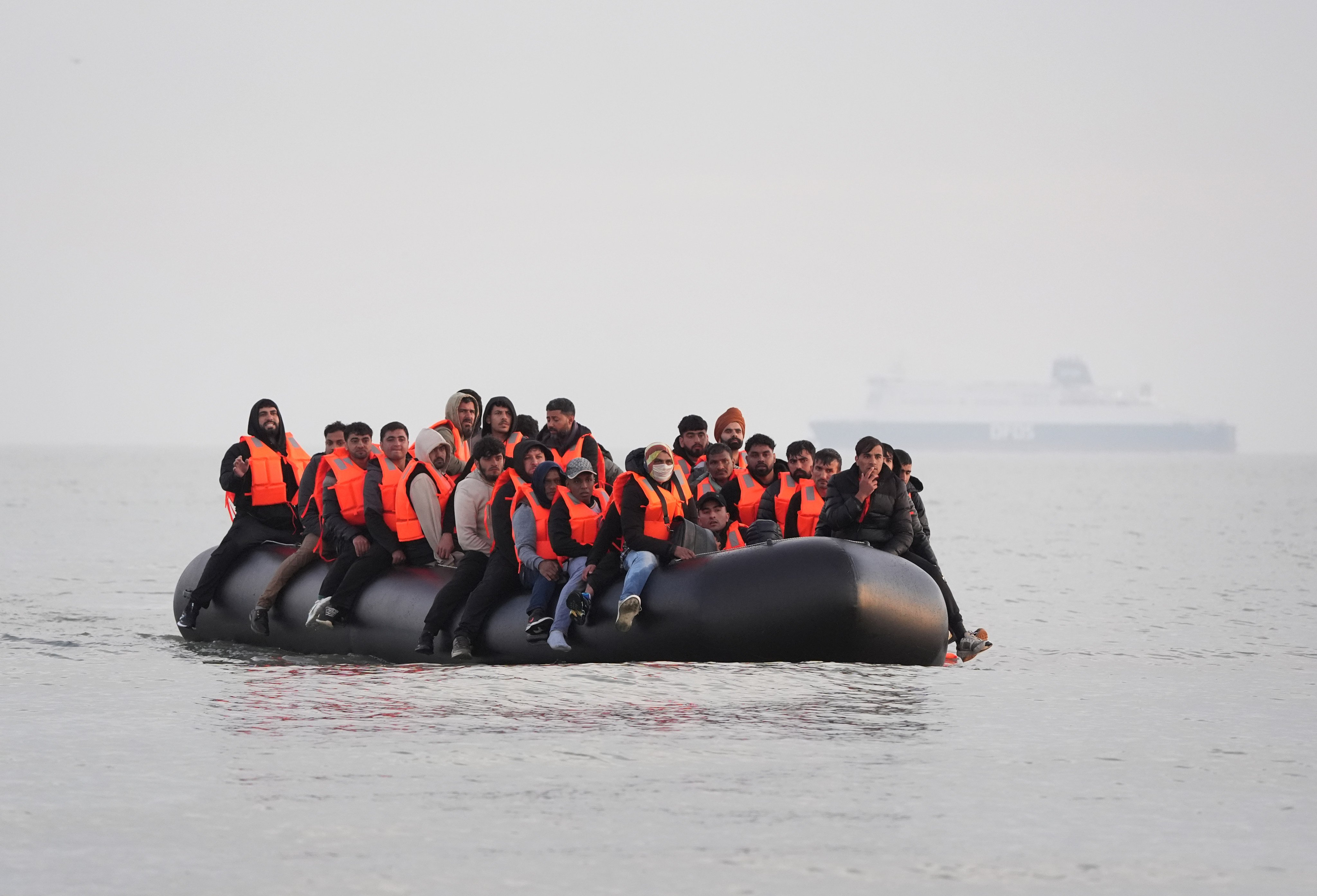 A group of people thought to be migrants on board a small boat leave a beach in France in May, attempting to reach the UK. Photo: dpa