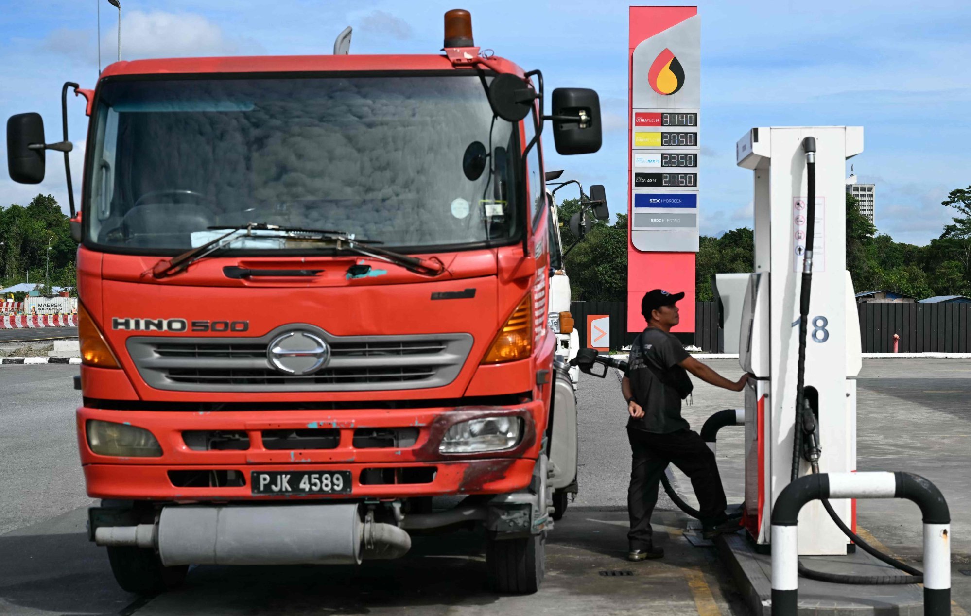 A man fills a lorry with diesel at a petrol station in Malaysia. Photo: AFP A man fills a lorry with diesel at a petrol station in Malaysia. Photo: AFP