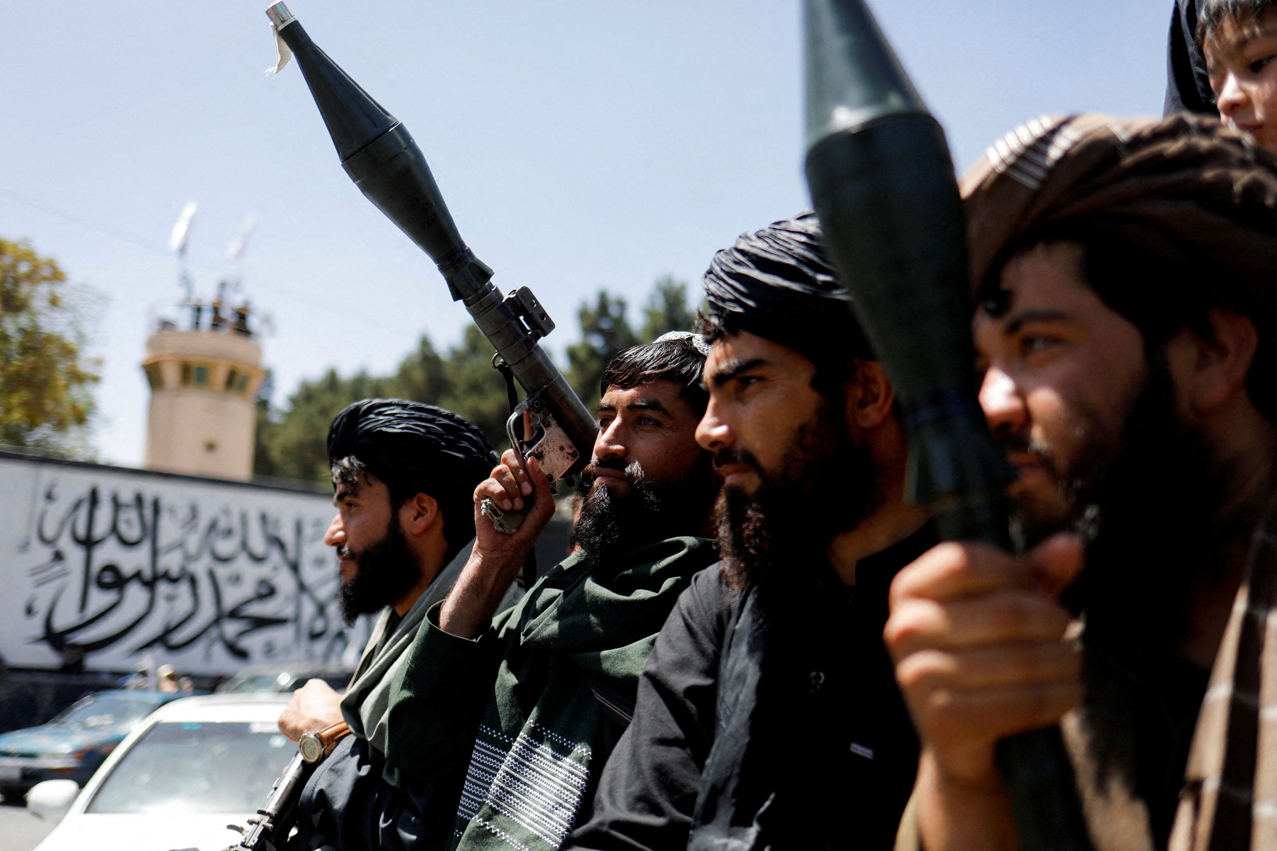 Taliban soldiers celebrate on the second anniversary of the fall of Kabul on a street near the US embassy in August 2023. Photo: Reuters