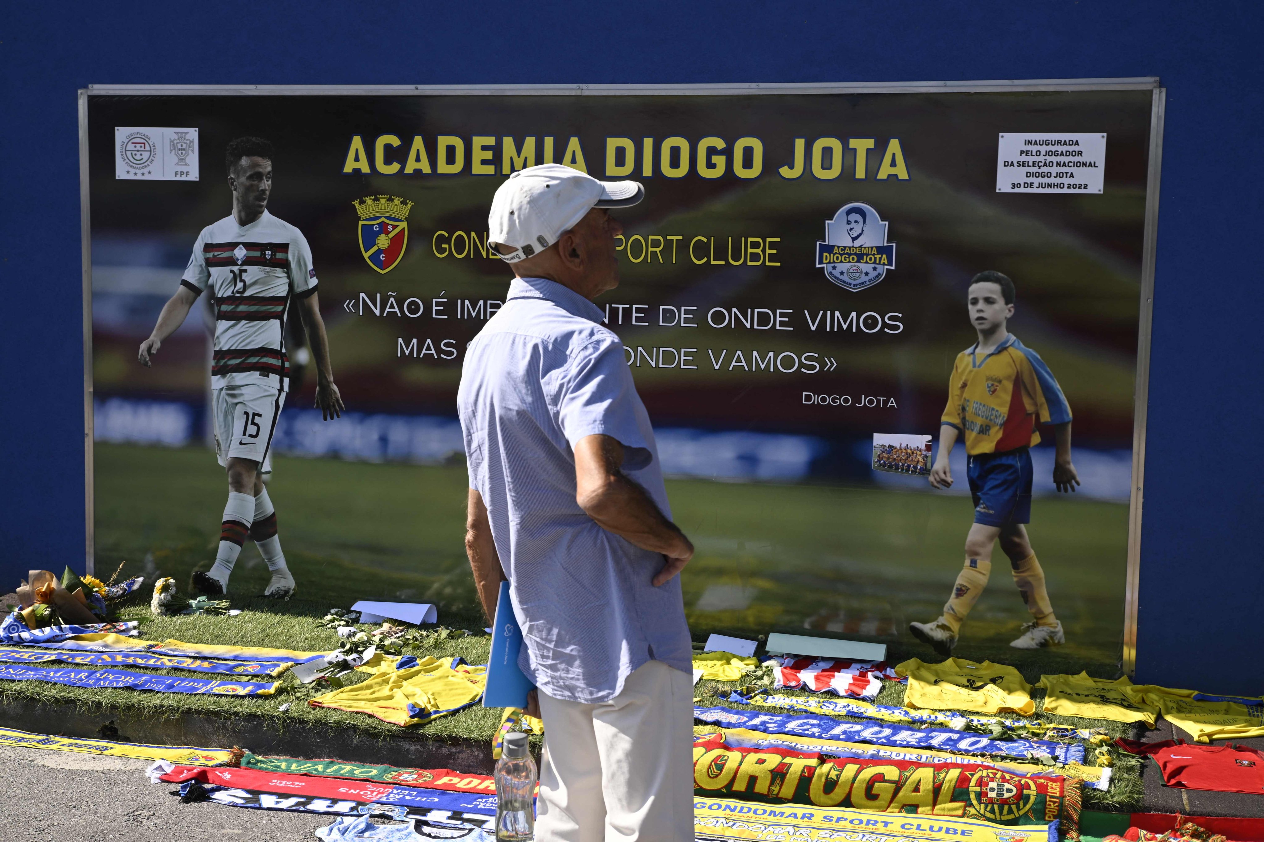 A man stands in front of a memorial on Friday for Liverpool’s Portuguese forward Diogo Jota, set up at the Gondomar Sport Clube’s stadium, where the late footballer began his career, in Gondomar, on the outskirts of Porto. Photo: AFP