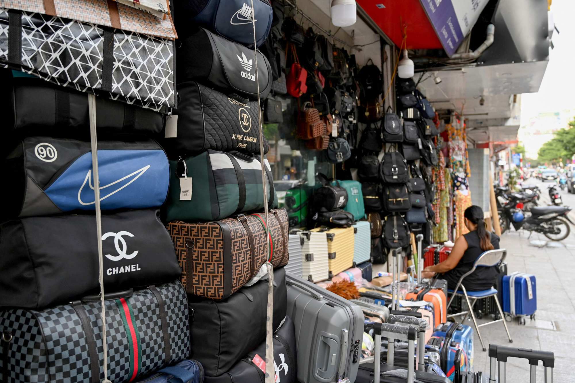 Bags with the logos of international fashion brands for sale outside a shop in Hanoi, Vietnam. Photo: AFP Bags with the logos of international fashion brands for sale outside a shop in Hanoi, Vietnam. Photo: AFP