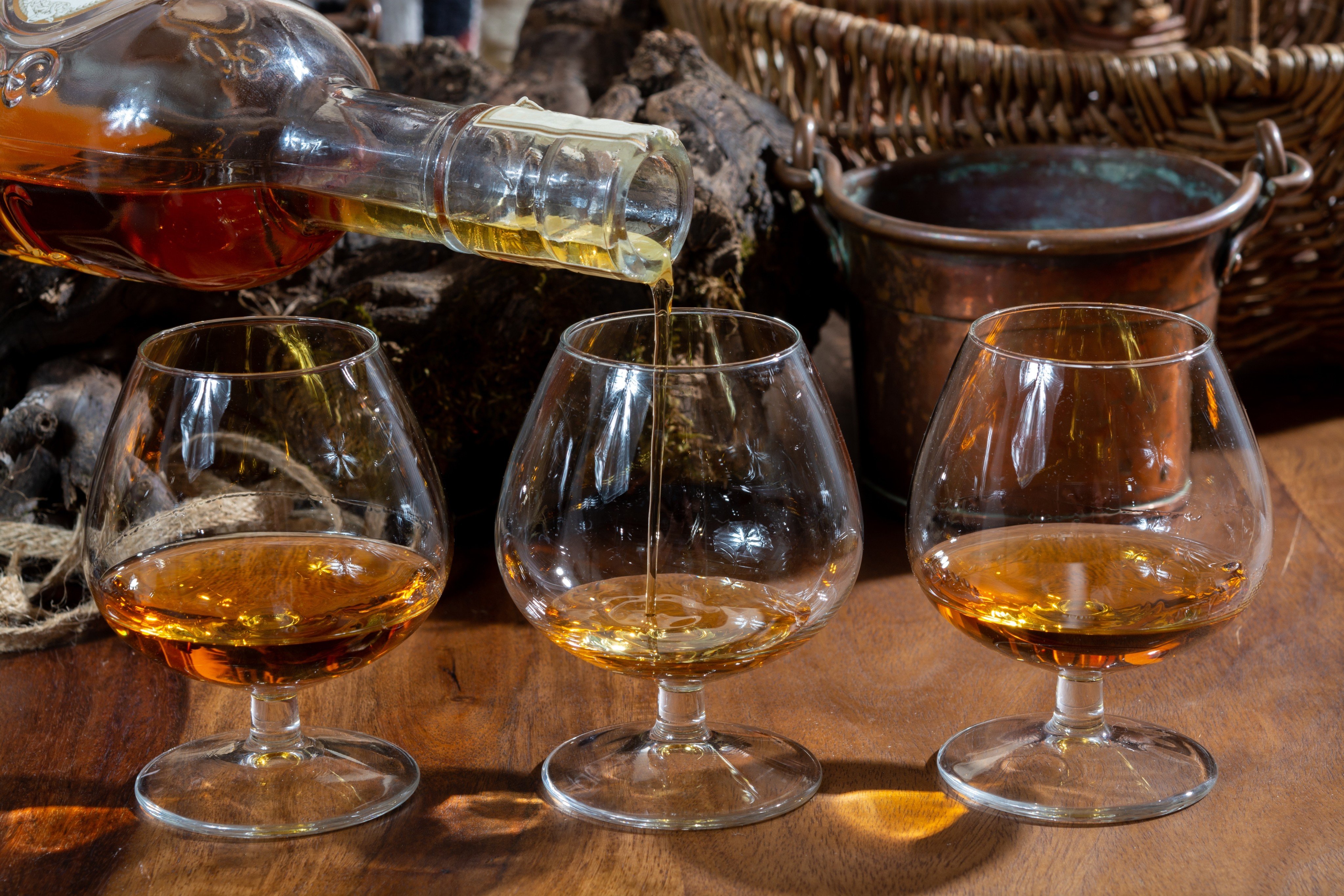 Tasting glasses of aged French cognac brandy are poured in France. Photo: Shutterstock